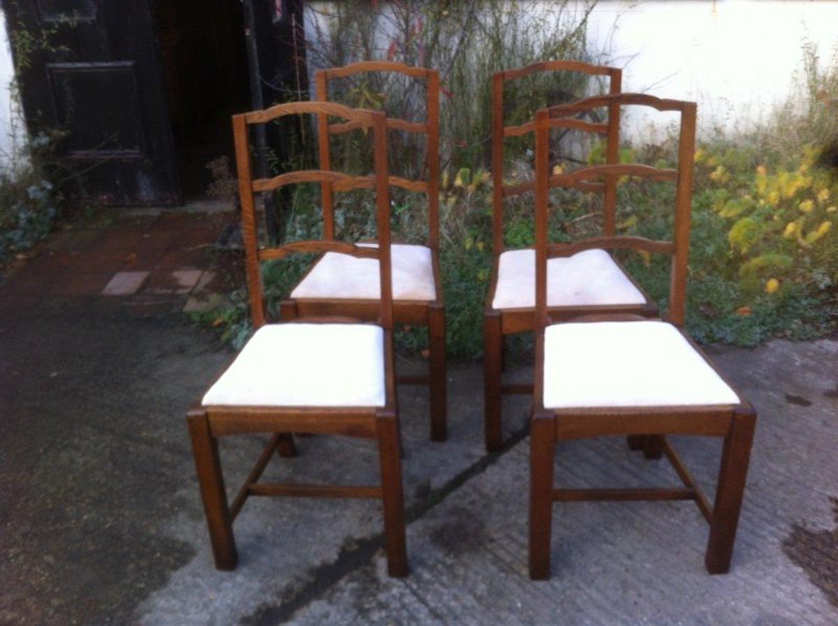 Heals attributed.
A set of four English Arts and Crafts oak arched top ladder back dining chairs in the Cotswold style. 
A good quality set with chunky legs and are all very sturdy indeed.
    