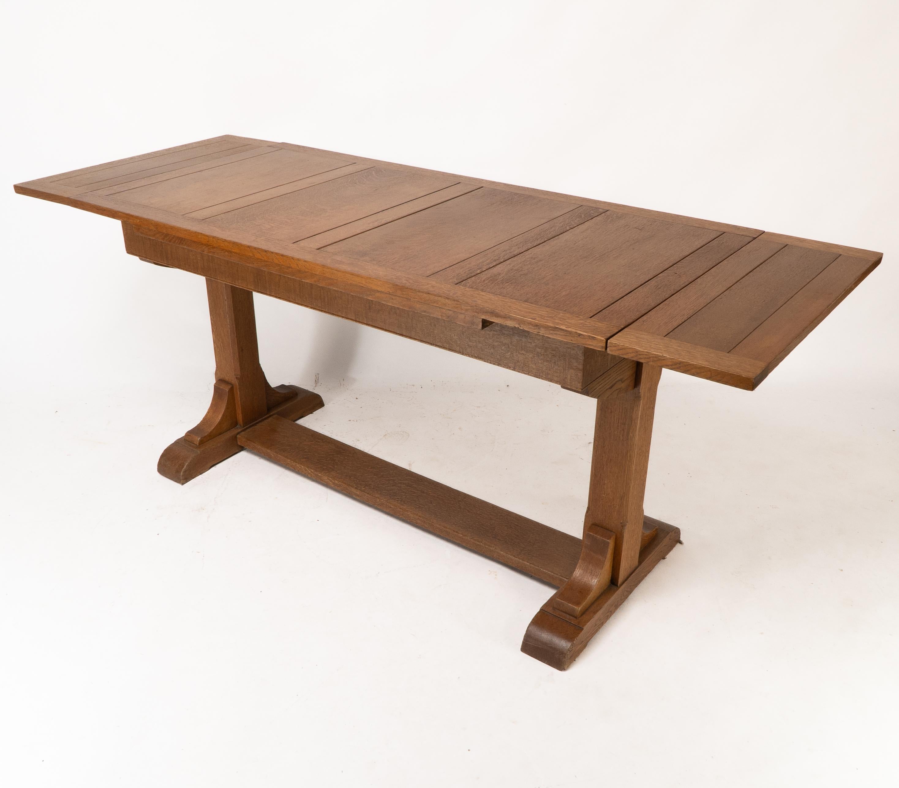 Oak Heals & Son. An Arts & Crafts narrow oak extending dining table For Sale