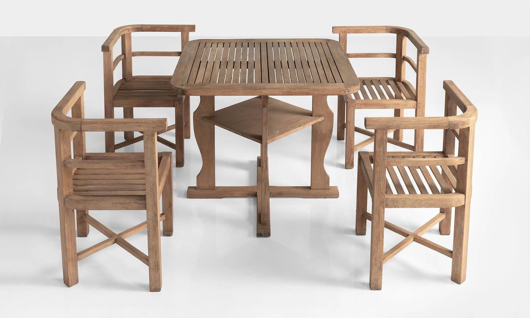 Heals teak garden set, England, circa 1930

Slatted teak table with chairs, made by Hughes Bolcklow for Heals of London.

Measures: Table: 33