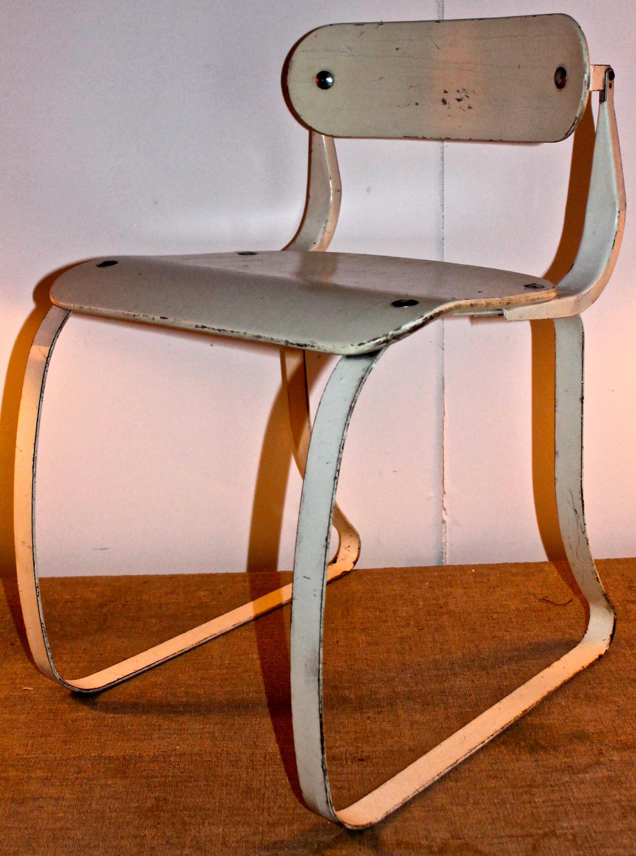 Important American modernist work chair designed for use with an ironing machine. Painted steel and lacquered plywood. This chair came to the attention of the design world when it was added to the permanent collection of the Museum of Modern Art