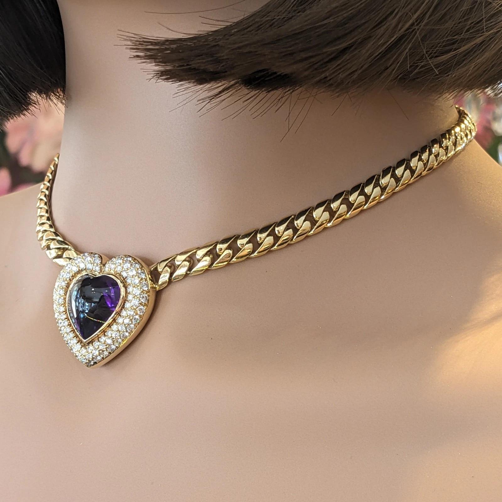 Heart Amethyst and Diamond Pendant Choker Necklace in 18k Yellow Gold

Amethyst and Diamond Necklace features a Heart shaped Amethyst Cabochon with Deep Purple color weighing approximately 7.50 carats surrounded by Round Brilliant Diamond pave set