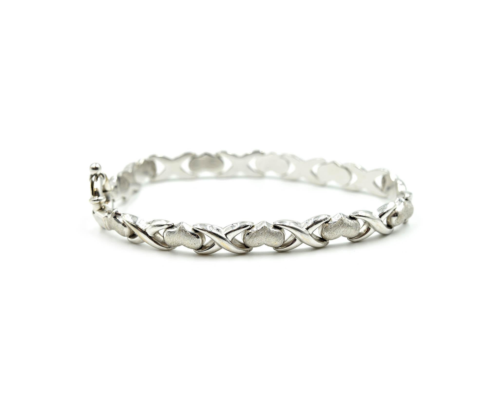 Designer: custom design
Material: 14k white gold
Dimensions: bracelet is 7 inches long and 1/4th an inch wide
Weight: 9.40 grams
