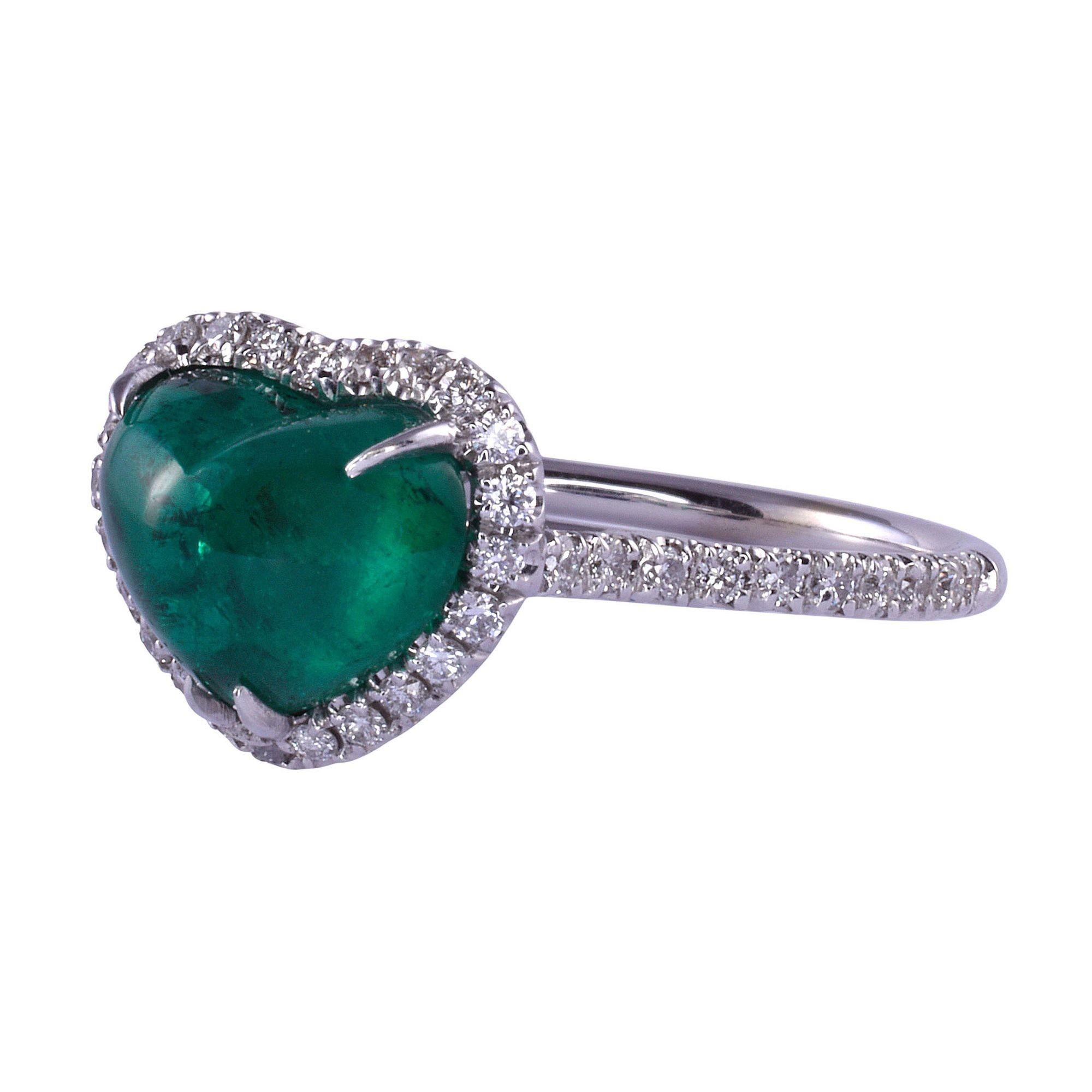 Estate heart cabochon Colombian emerald ring. This heart ring is crafted in 18 karat white gold featuring a 2.45 carat heart shaped cabochon Colombian emerald. The heart emerald ring has .35 carat total weight of diamond accents and is excellently