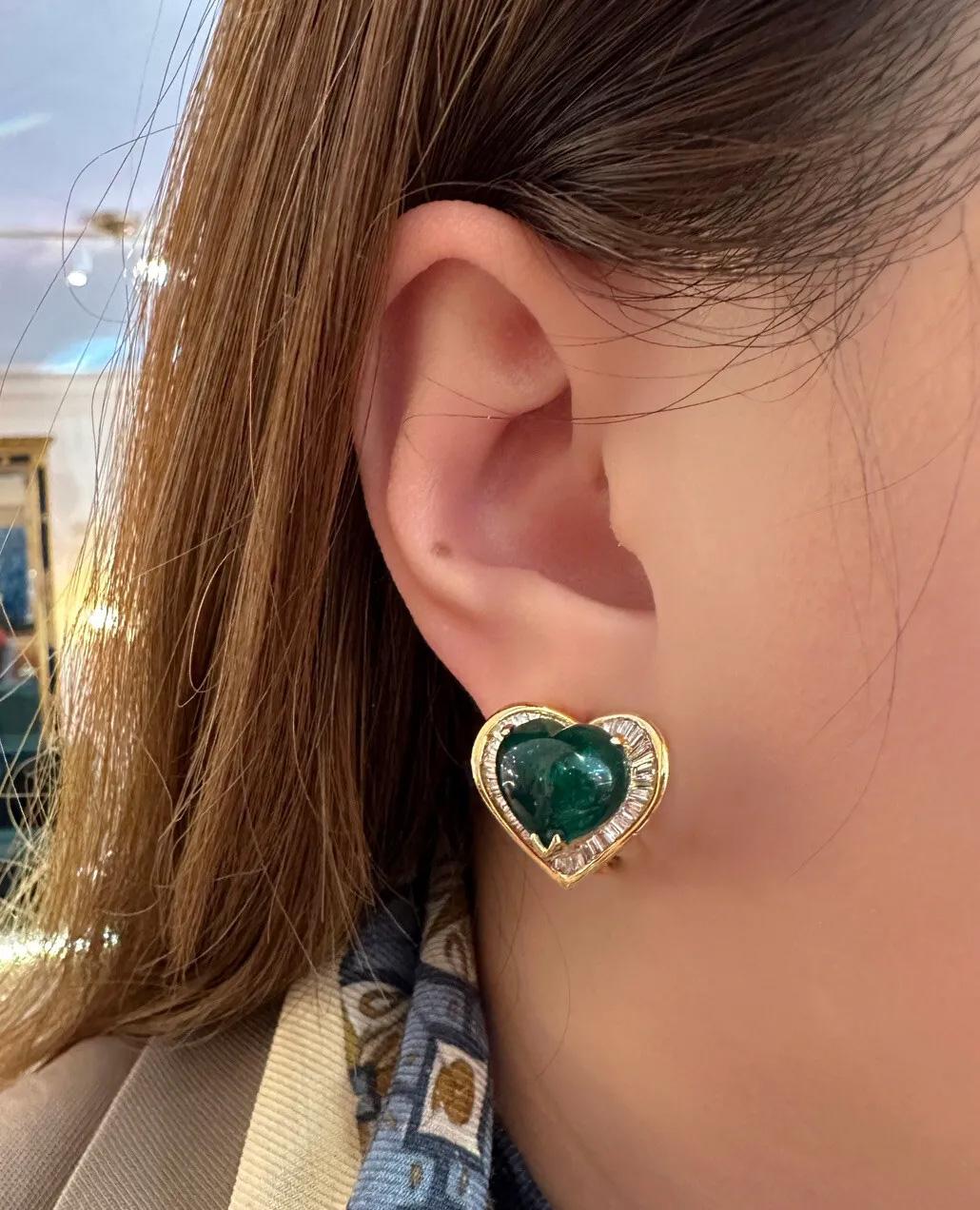 Heart Cabochon Emerald and Baguette Diamond Earrings in 18k Yellow Gold

Emerald and Diamond Earrings features Natural Heart shaped Cabochon  Emeralds surrounded by Baguette Diamonds set in 18k Yellow Gold. Made for pierced ears and secured by an
