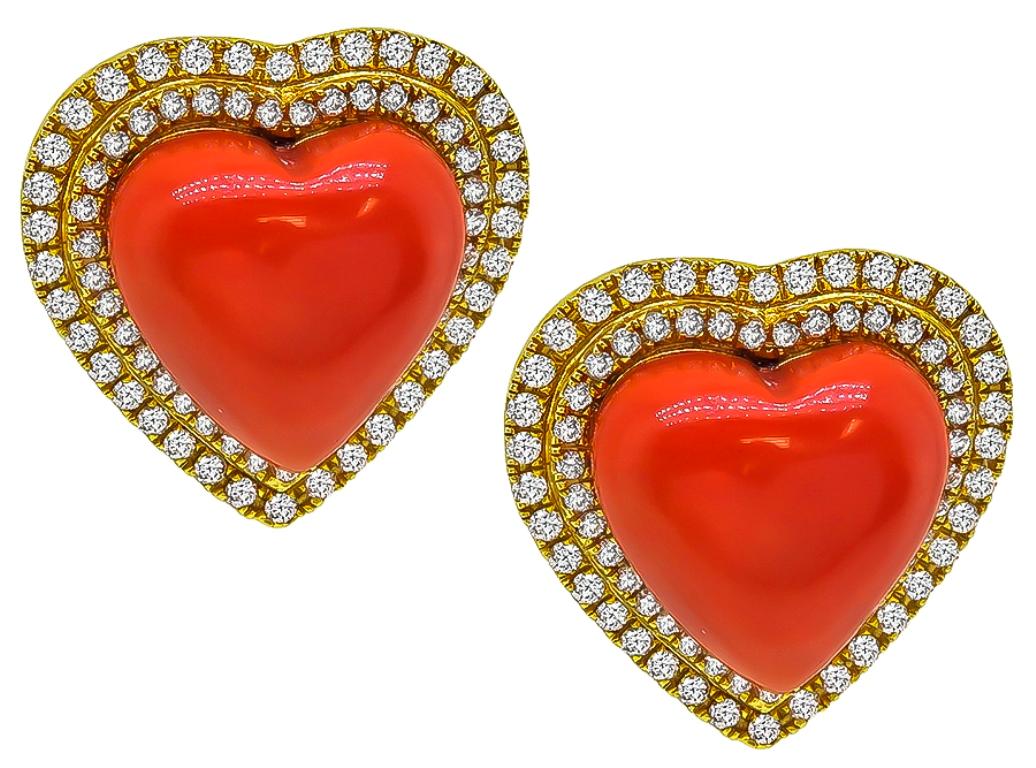 This stunning pair of 18k yellow gold heart earrings feature lovely heart shape corals which are accentuated by sparkling round cut diamonds that weigh approximately 0.75ct. graded F-G color with VS clarity. The earrings measure 19mm by 19mm and