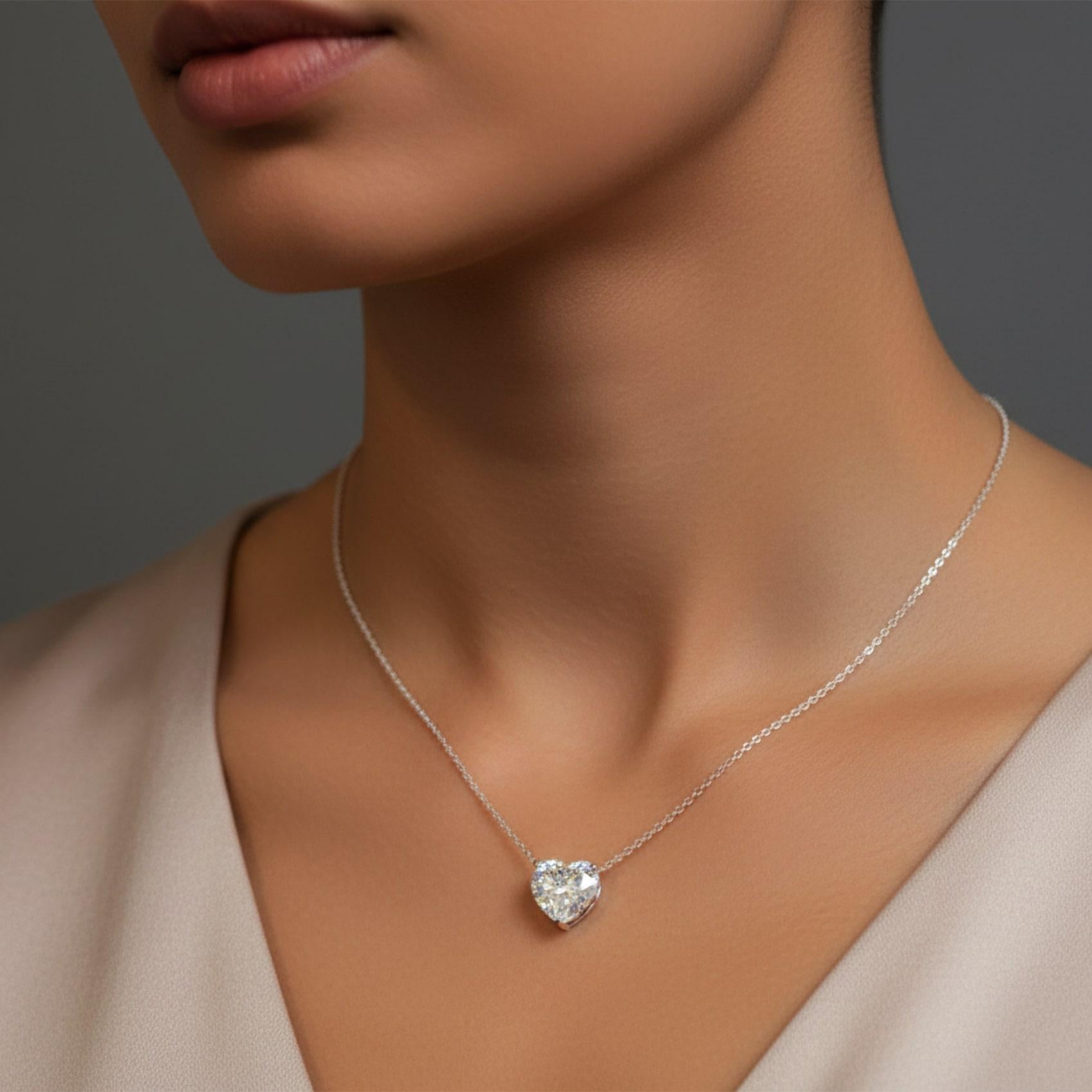 Célébrez l'élégance intemporelle avec ce superbe pendentif en diamant taillé en cœur de 1,75 carat, magnifiquement suspendu à une fine chaîne en or blanc. La taille brillante en forme de cœur, réalisée de manière experte, capte la lumière sous tous