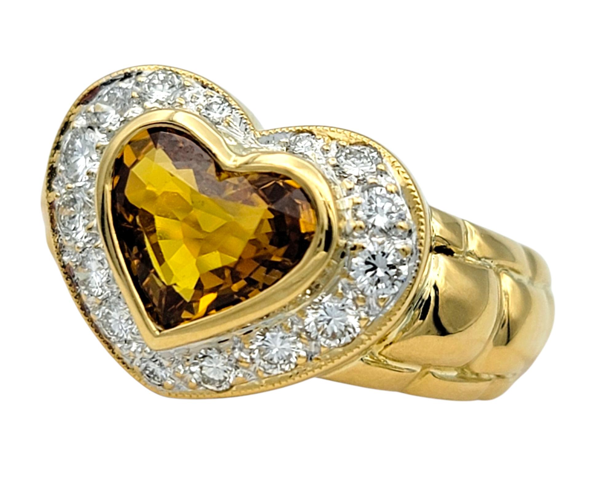 Ring Size: 6

This heart-shaped ring showcases a vibrant orangish yellow citrine at the center, cut in a romantic heart shape and surrounded by a pavé halo of round diamonds. The contrasting tones between the rich golden hue of the citrine and the