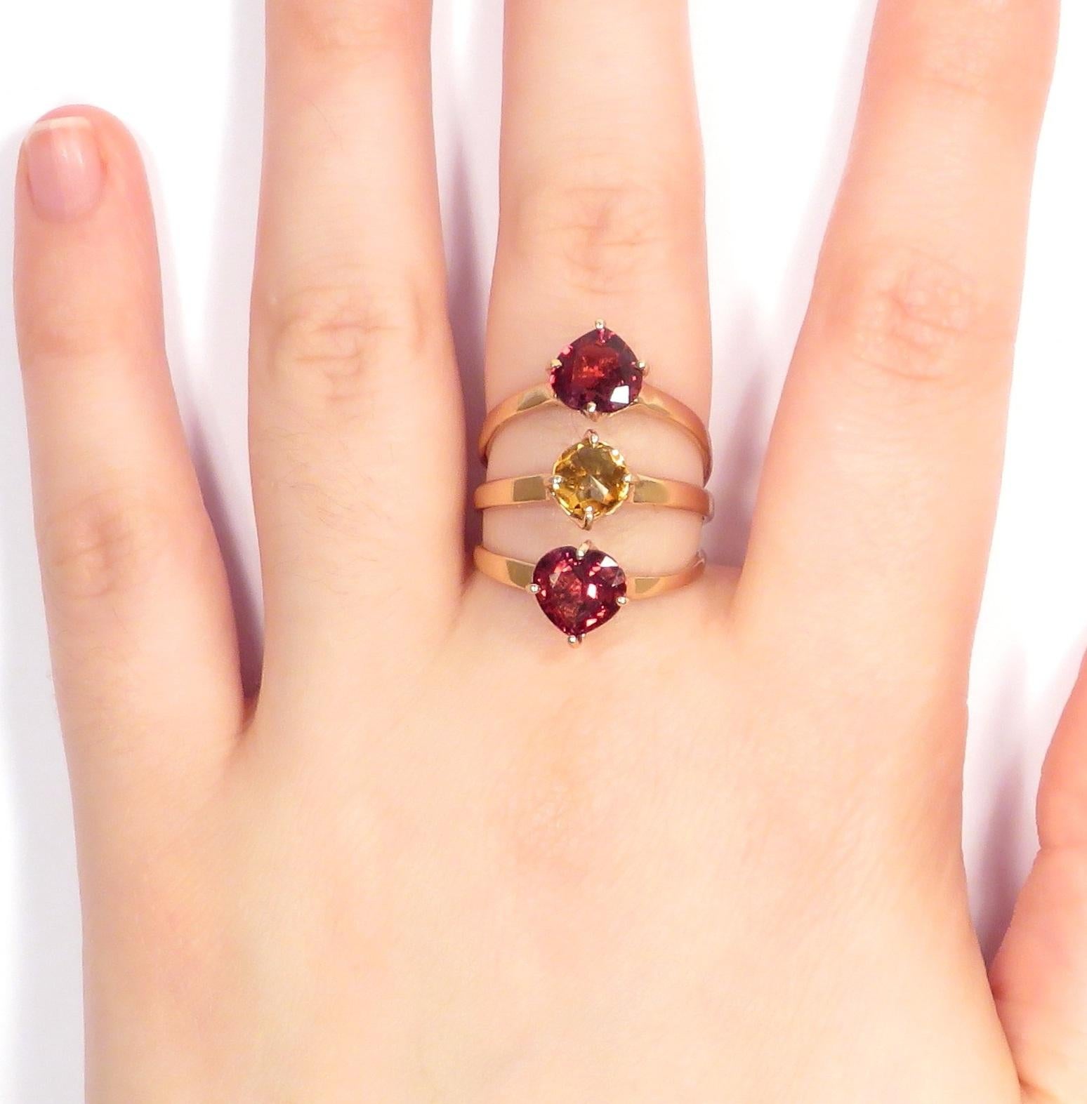 Three rings merge into one for an outstanding ring in 9 karat rose gold with 2 natural heart cut garnets and 1 rose cut yellow citrine. US finger size is 7, French size 55, Italian size 15, it can be resized to the customer's size before shipment.