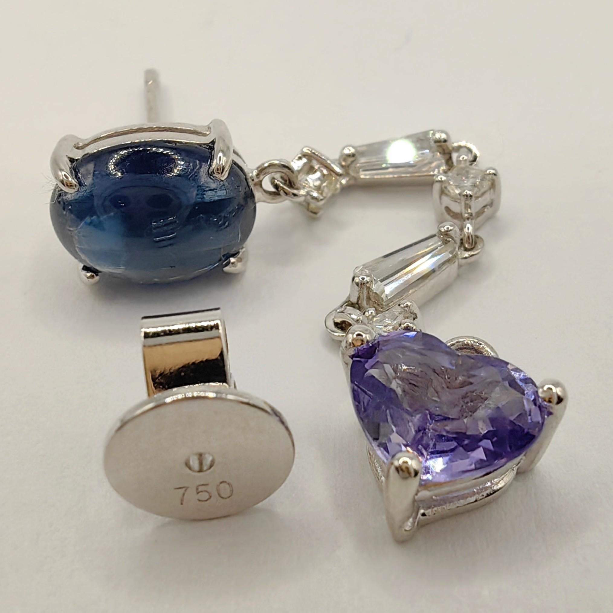 Unser violetter Ohrring mit Herzschliff und Cabochon aus blauem Saphir und Diamant aus 18 Karat Weißgold ist ein einzigartiges Schmuckstück, das ein mutiges Modestatement setzt. Dieser Unisex-Ohrring ist nicht einfach nur ein Accessoire, er ist ein