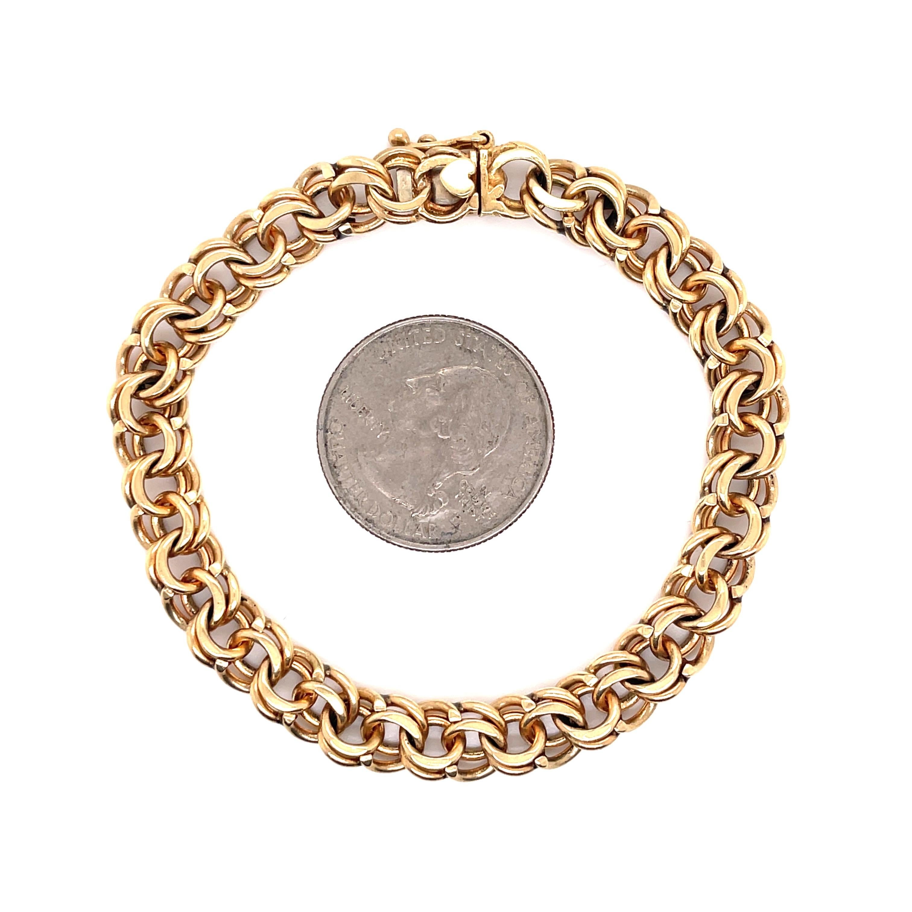 14 Karat yellow gold bracelet featuring 45 double links weighing 23.4 grams with a heart detail clasp. 
7.5