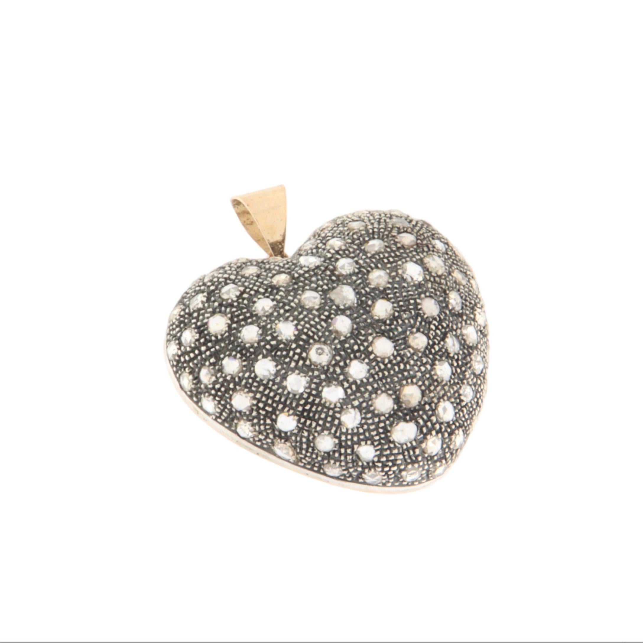 Charming handcrafted heart-shaped pendant, made with precious materials rich in character and history. This unique piece combines the timeless elegance of 14 karat yellow gold with the refined appeal of 800 silver, creating a sophisticated and