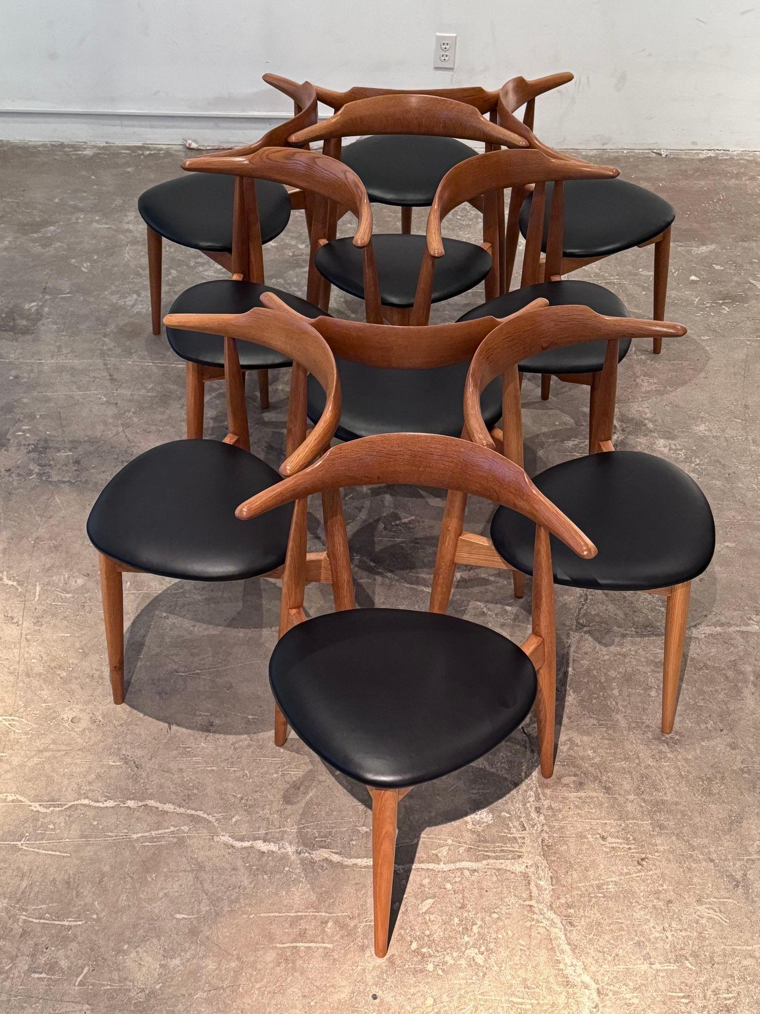If you've been looking for a large number of unusual dining chairs, this is it. Set of ten Heart dining chairs designed by Hans Wegner, 1952 for Fritz Hansen Constructed of oak with new leather seats, In 1951, Hans Wegner designed chairs were