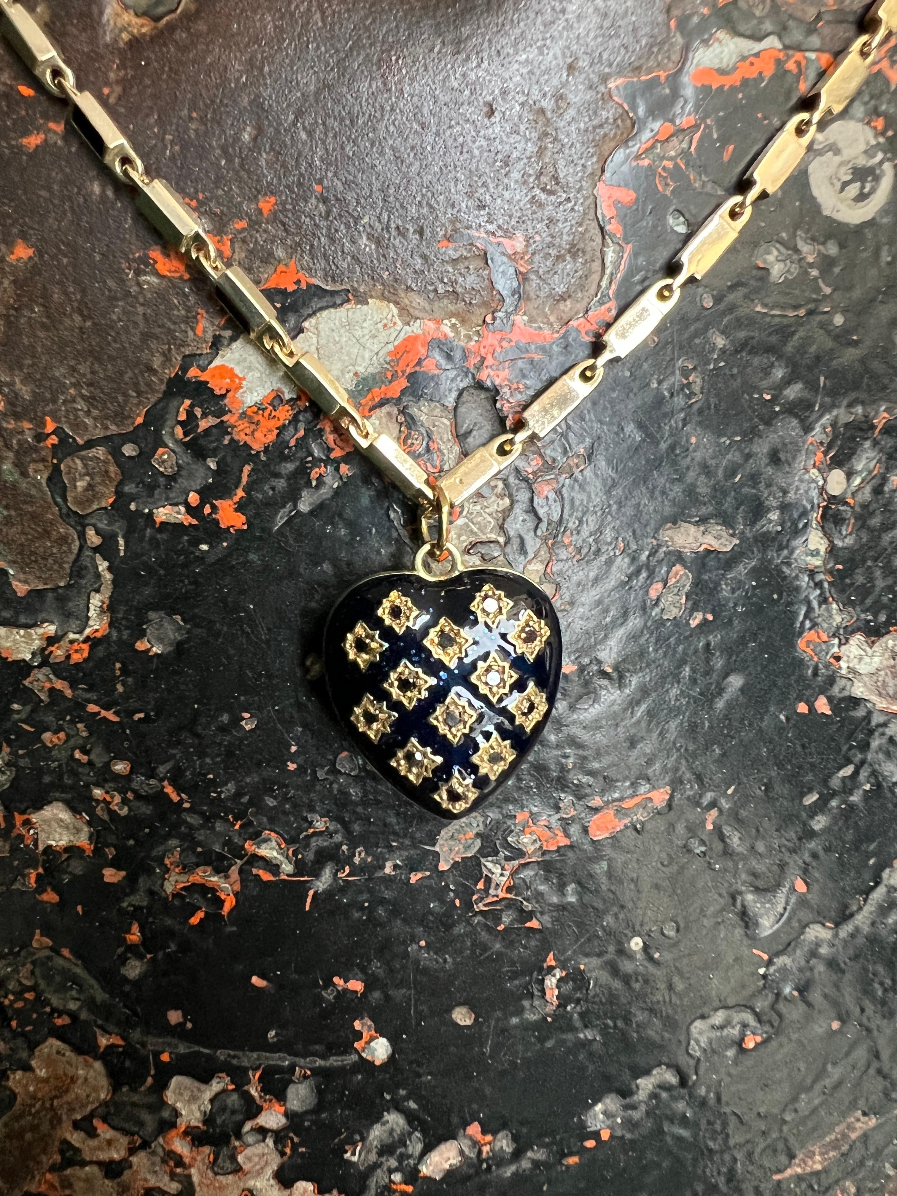 Heart Pendant Necklace White Diamond by J DAUPHIN 
Designer: J DAUPHIN

Materials:
– Chain: Gold-plated brass, hand-painted black enamel 
– Pendant: 14k gold-plated brass, hand-painted black enamel
– Gemstones: white diamonds, mini white