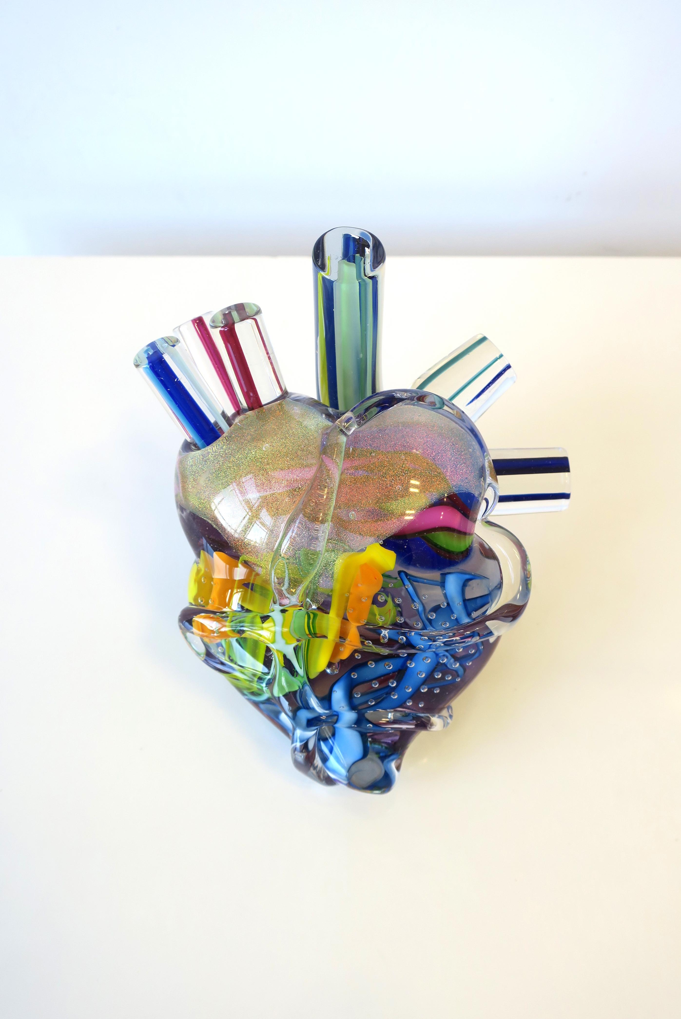 A very beautiful and substantial 'Heart of Glass' art glass sculpture depicting a human heart signed by artist (unknown), circa 21st century. Shimmering, transparent and brightly colored art glass make up this 'human heart' contemporary art, art