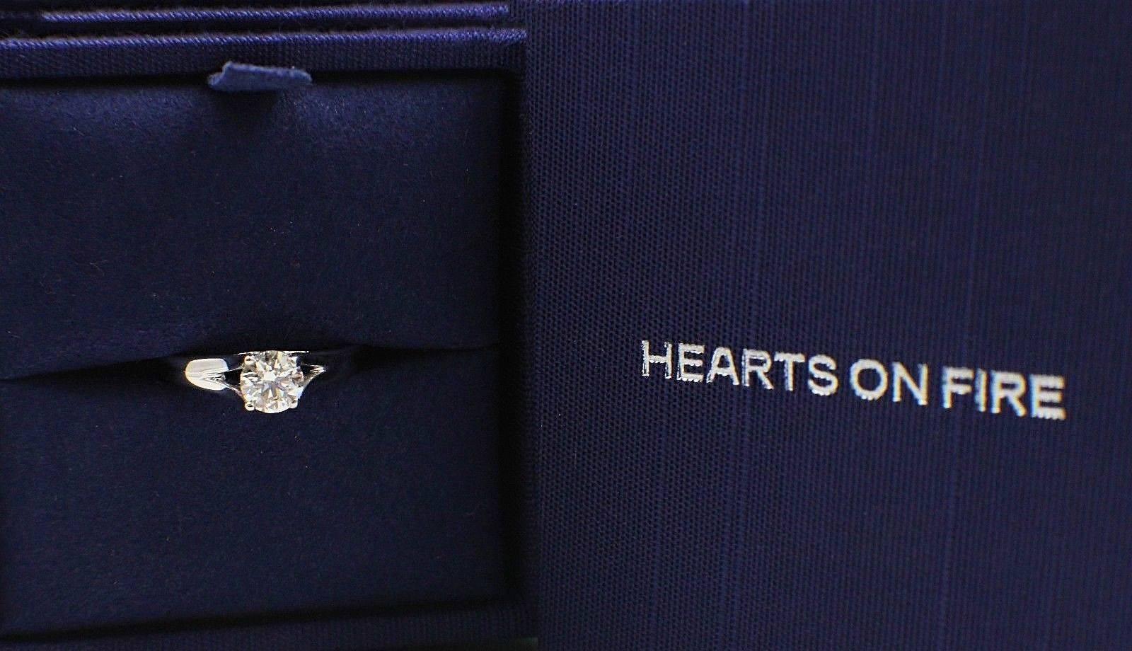 Brand: HEARTS ON FIRE
Style:  Seduction Solitaire Diamond Engagement Ring
Serial Number: HOF 104599 (Hallmarked inside the ring )
Metal: White Gold 14KT
Total Carat Weight:  0.593TCW
Diamond Shape: Round Brilliant Ideal Cut
Diamond Color: G
Clarity: