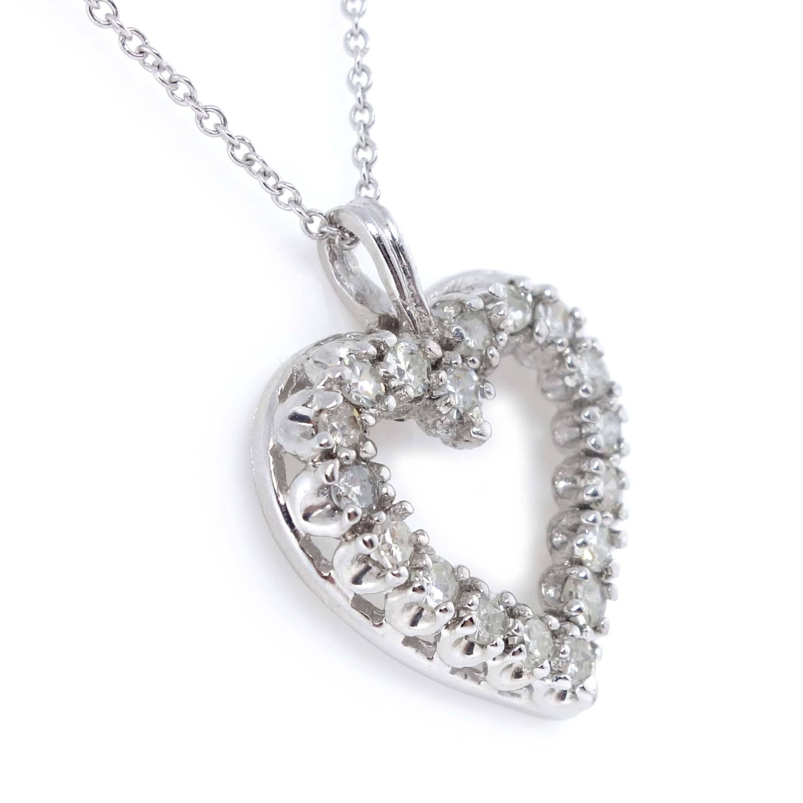 Heart Pendant containing 17 round brilliant cut Diamonds of about 0.35 carats with a clarity of SI2 and color H. All diamonds are set in a 14k white gold pendant. The total weight of the pendant is approximately 2.06 grams.

Measurements: (W x H)