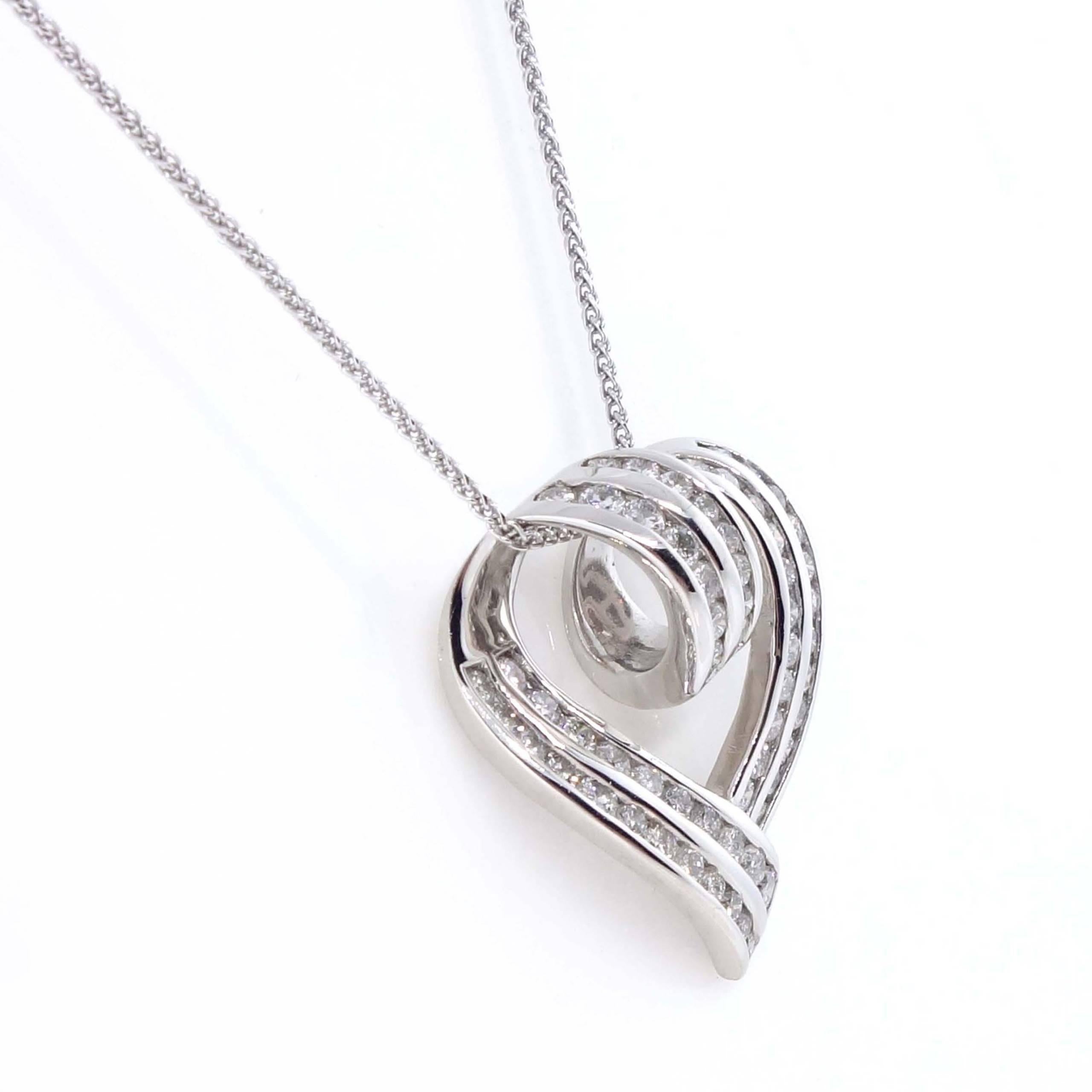 Heart pendant containing 60 round brilliant cut diamonds of about 1.05 carats with a clarity of SI2 and color H. All diamonds are set in a14k yellow gold pendant. The total weight of the pendant is approximately 6.88 grams.

Measurements: W 0.80 x H