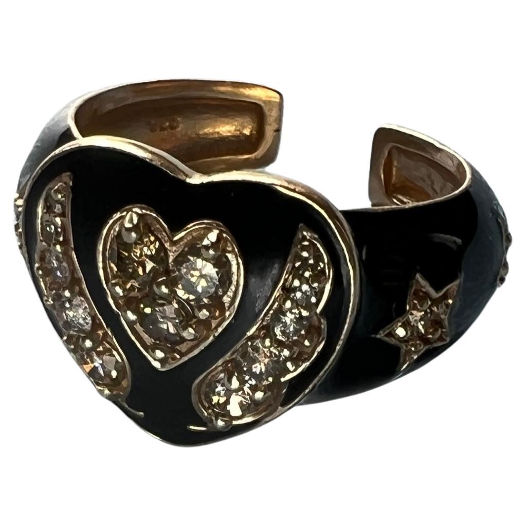 White Diamond Heart Ring Black Enamel
This Ring is made in 14k Gold Plated Silver

Designer: J Dauphin

Heart Ring with several Single Cut White Diamonds made with Black Enamel, on the side of the stars it has two angel wings and on the band there