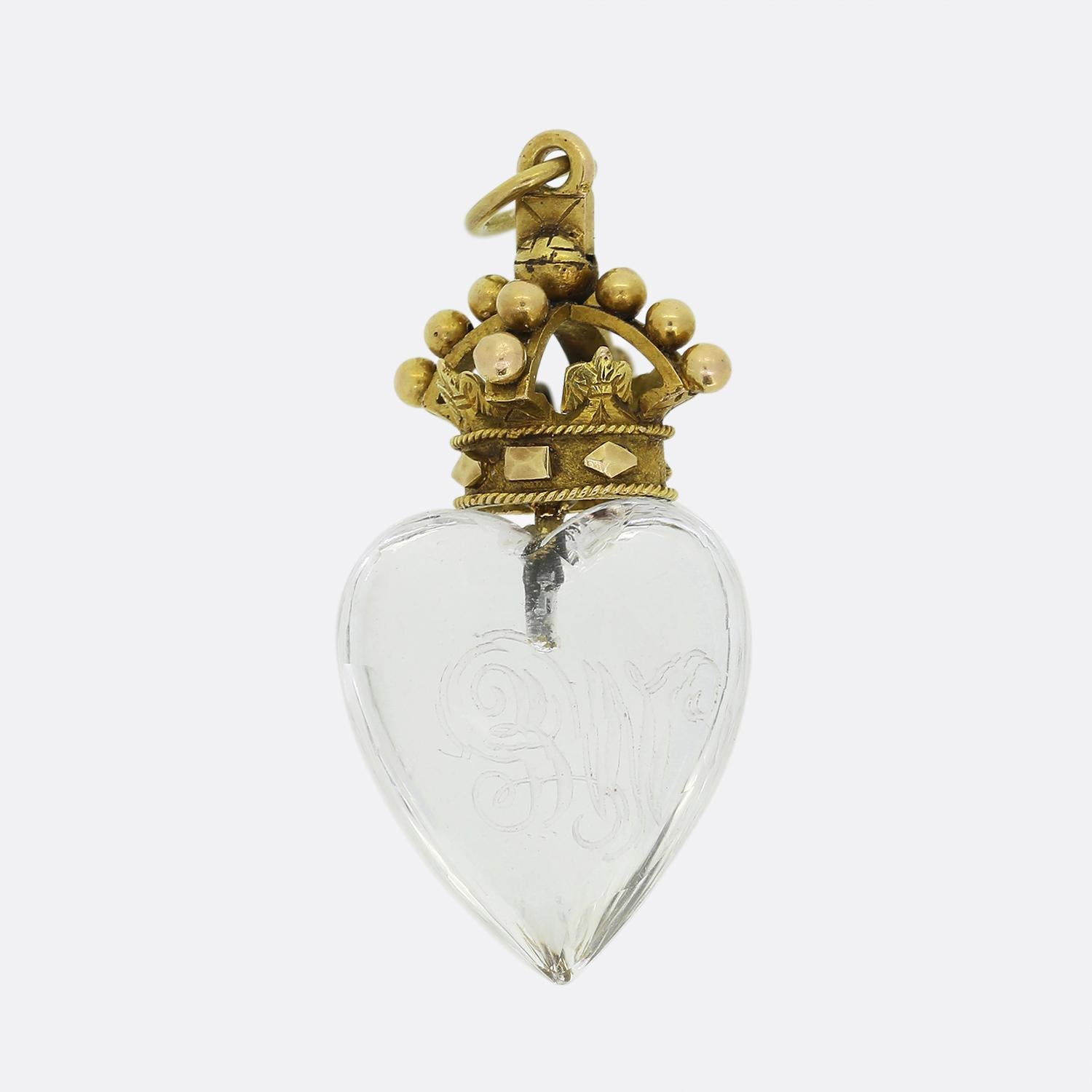 Here we have a gorgeous antique pendant expertly crafted into the shape of a heart from colourless rock crystal stone and engraved with the initials 'WE'. This focal stone is then surmounted by a highly decorated crown showcasing dove motifs, beaded