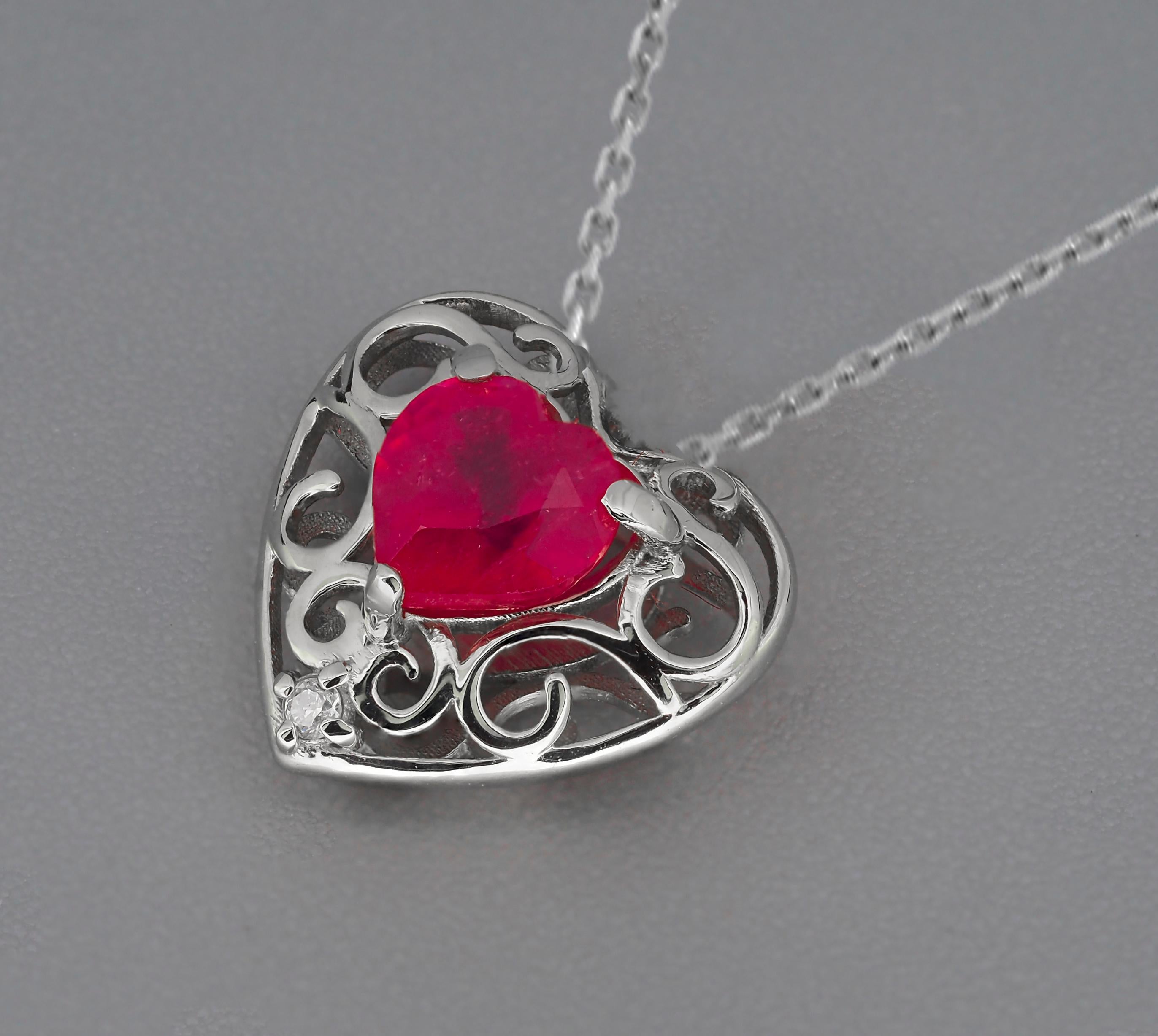 Heart Ruby, diamond 14k gold Pendant. 
July Birthstone pendant necklace. Red heart solitaire pendant. Simple, everyday pendant. Love pendant.

Metal: 14k gold
Weight: 1.1 g.
Pendant size in mm - 11x14.5 mm.

Central stone: Ruby
Cut: heart
Weight: