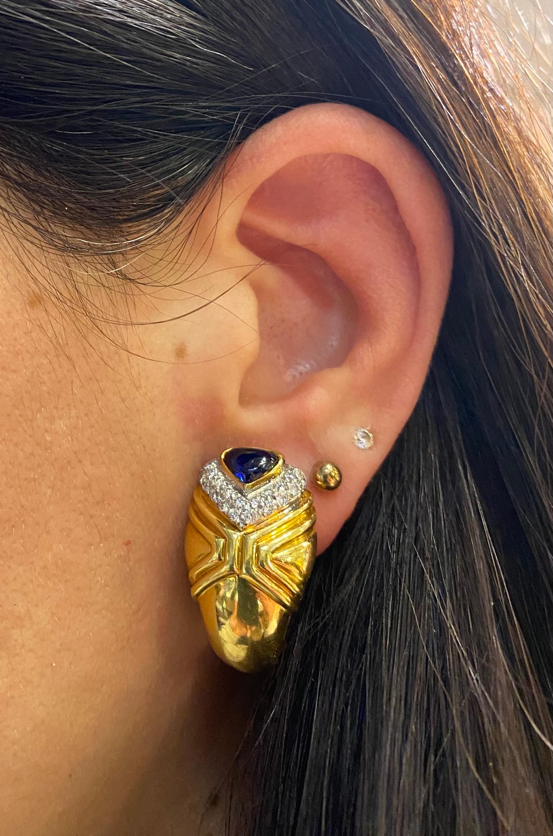 Heart Shape Cabochon Sapphire & Diamond Earrings 

Earrings featuring two exquisite cabochon-cut sapphires weighing approximately 2.65 carats, accented by 40 round diamonds  weighing approximately of 0.72 carats.

Back Type: clip on 

Measurements: