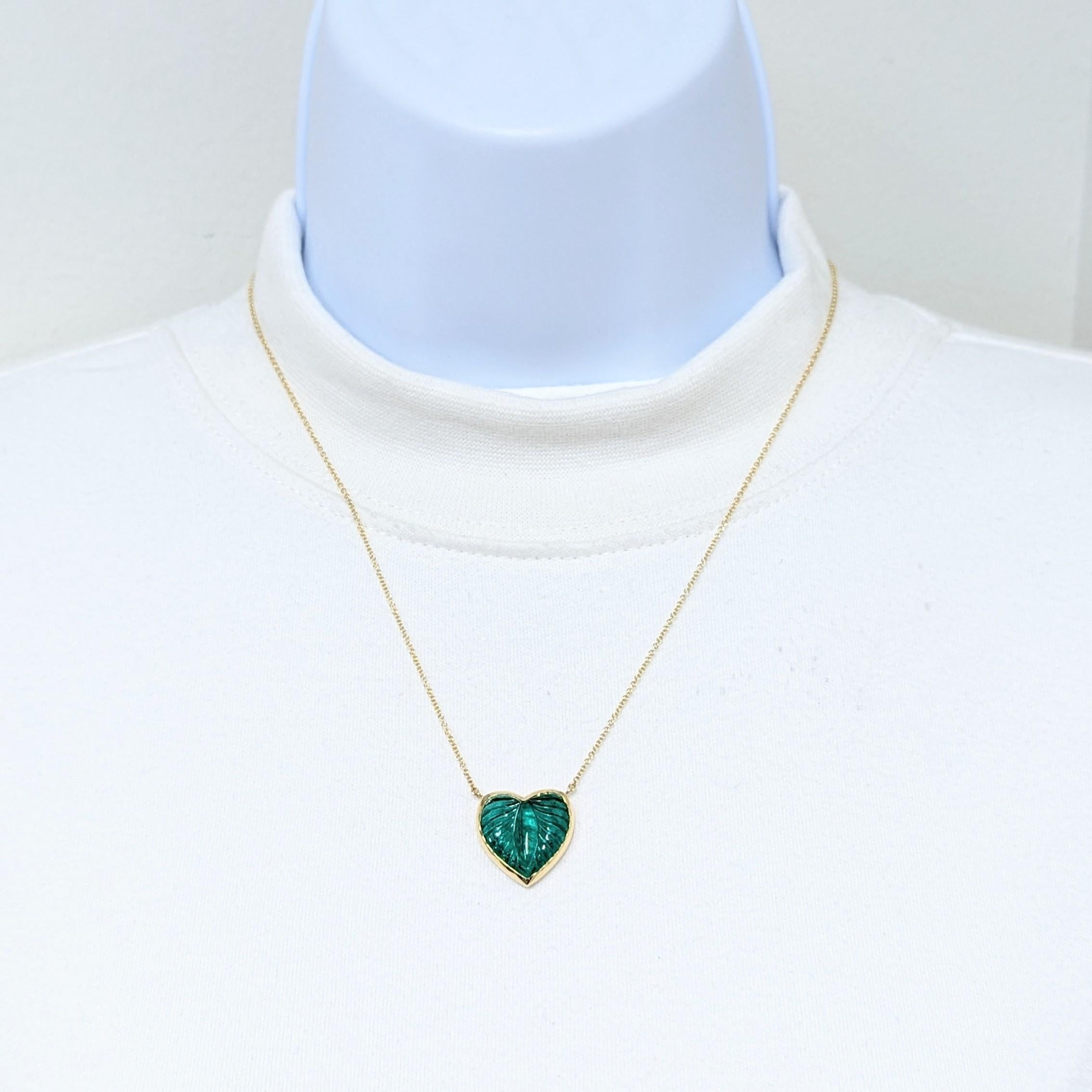 Beautiful 9.59 ct. carved emerald heart shape in a handmade 18k yellow gold mounting and chain.  Length is 18.5