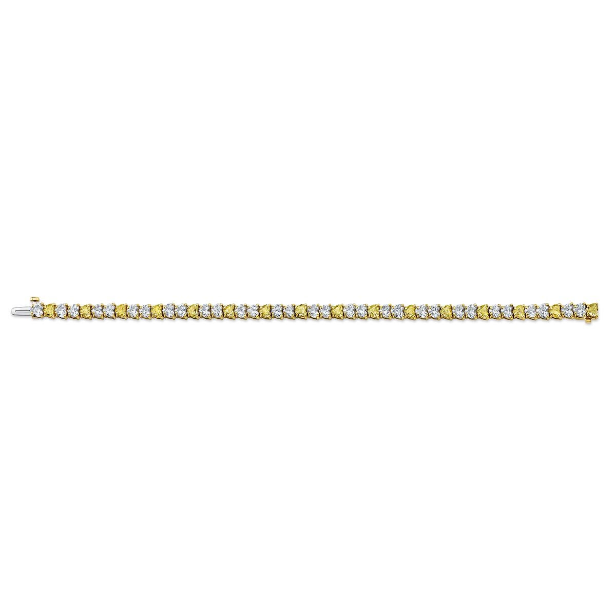 Alternating white and yellow  heart shape diamonds set in 18k yellow gold bracelet
47 stones 11.69 carats total weight
16 Natural Yellow HS Diamonds / 31 White HS Diamonds