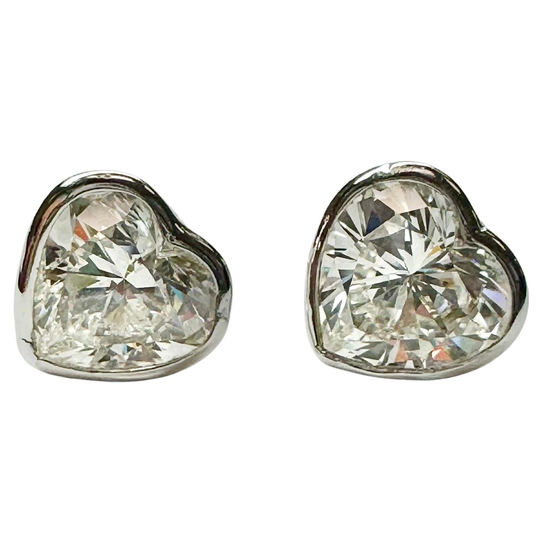 Unique Heart shape pair of diamond earring studs, set in custom handmade Tiffany & Co. platinum mounting. 
Beautifully matched white diamonds, with no dark inclusions. 
Diamonds are accompanied with GIA reports
GIA2225298893 2.02 H SI2
GIA5222298892