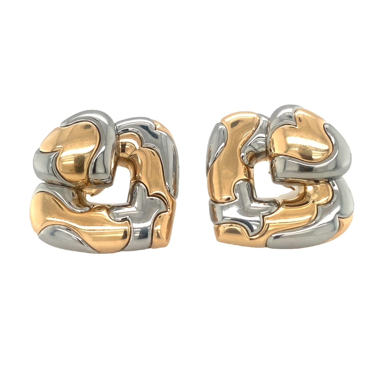 Heart-shaped earrings with patchy, off-setting yellow gold and stainless steel design and high polish finish throughout attributed to Marina B. Features posts and Omega backs. Circa 1980s.

Substantial, bold, sleek.

Additional information:
Metal: