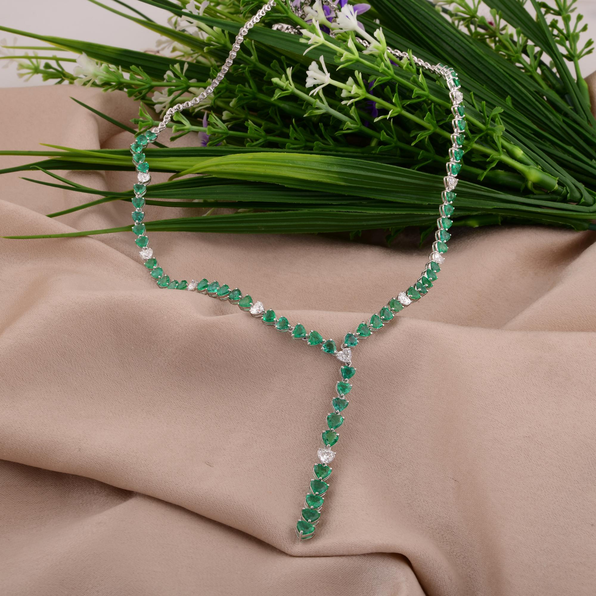 Immerse yourself in the romantic elegance of this handmade heart-shaped emerald and diamond necklace, a stunning piece of fine jewelry crafted in 14 karat white gold. At the center of the necklace lies a captivating heart-shaped emerald, renowned