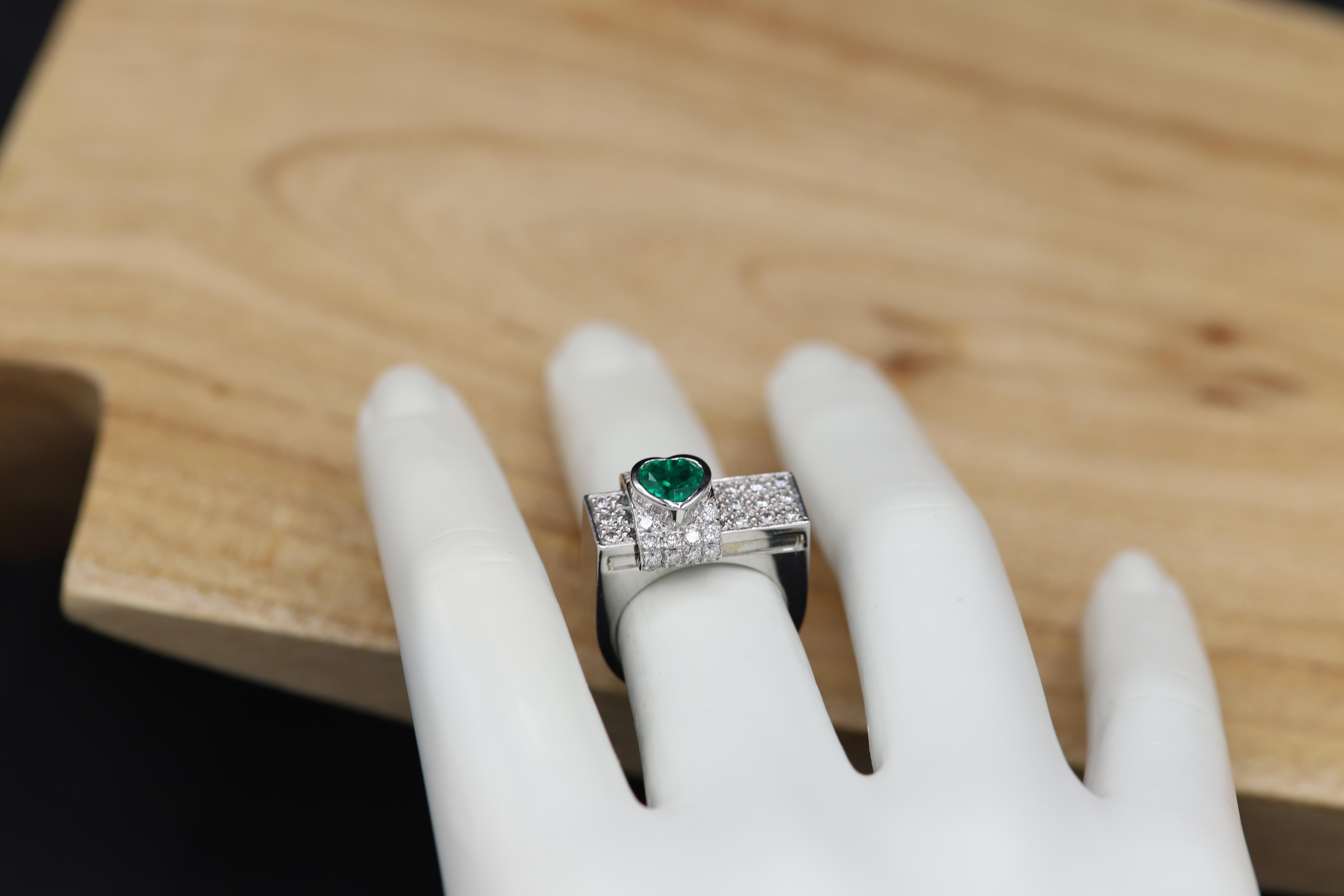 Sliding - Moving Emerald with round Diamonds ring.
Elegant Heart and good green Color
Emerald is 0.90 carat /  6 mm. 
Total Diamonds 1.15 carat GH-VS-SI.
18k White Gold 15.30 grams.
Finger size 6.5

 