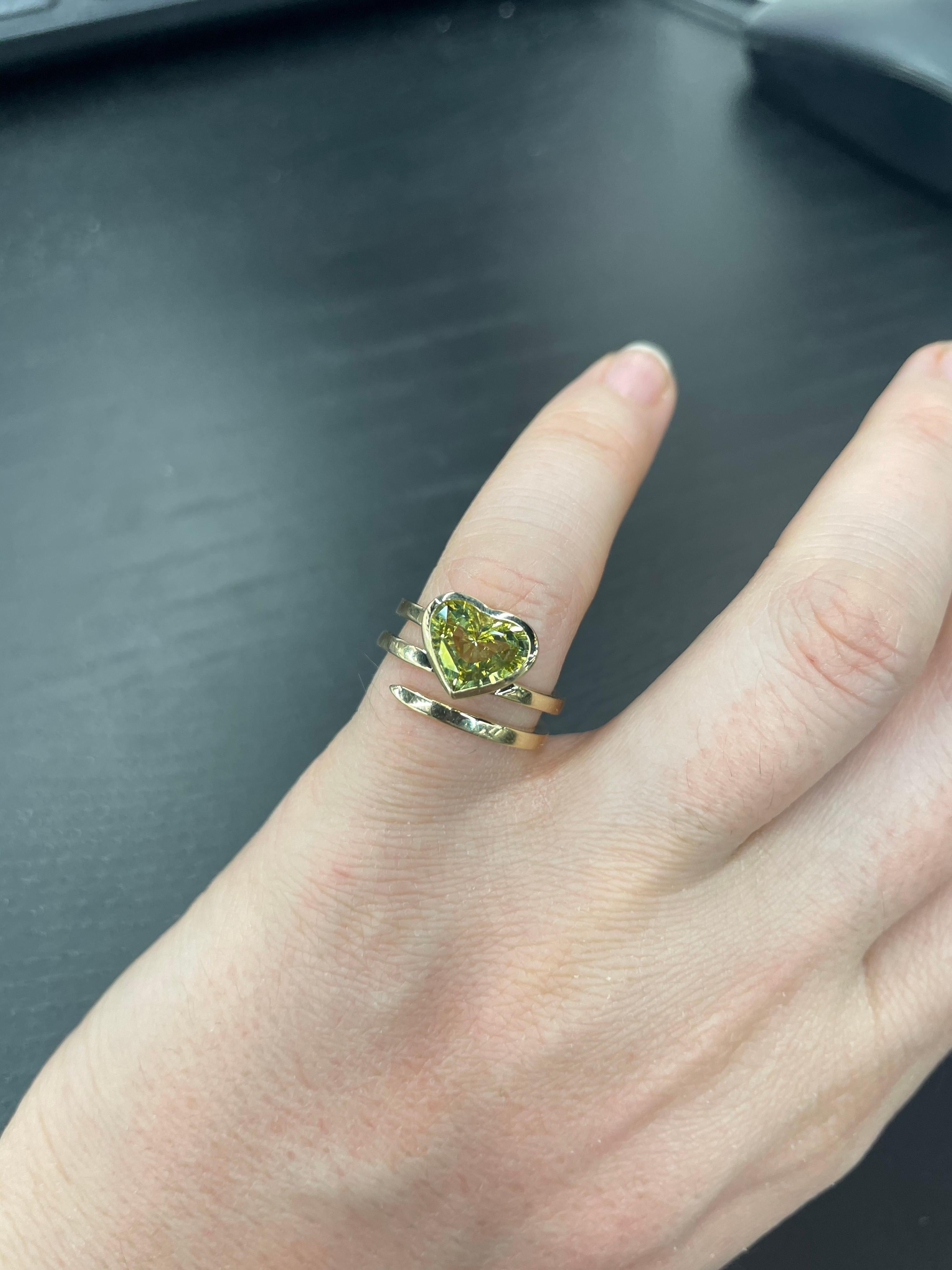 14 Karat Yellow gold fashion wrap ring featuring one Heart Shape Chrysoberyl weighing 2.13 carats in a bezel ring. 
