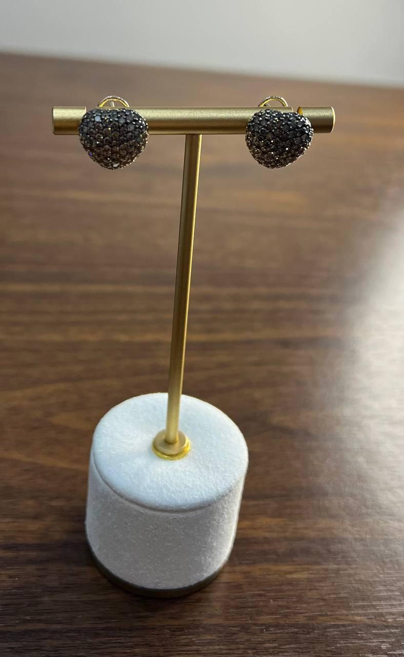 Embrace elegance with these stunning stud earrings; the heart-shaped design is encrusted with shimmering diamonds of champagne cognac colors, creating a captivating sparkle. Sophisticated and timeless. 14K Yellow Gold.