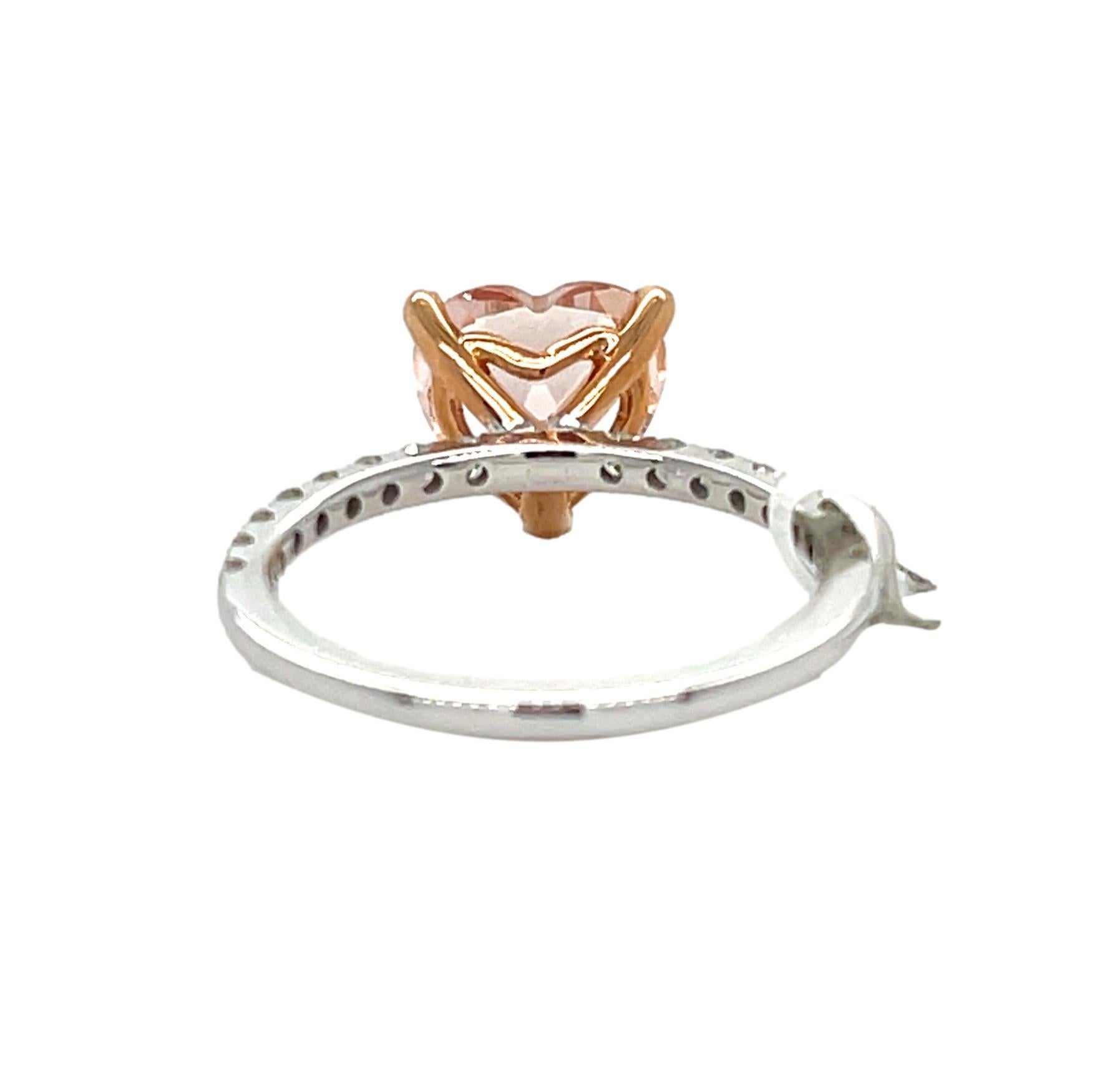 This stunning ring has a 9.5 mm heart shape Morganite center which is 3 prong set in 14 White gold with Rose gold prongs. This ring has a straight shank with shimmering diamonds on it for a perfect accent all set in 14 kt White gold. This ring will