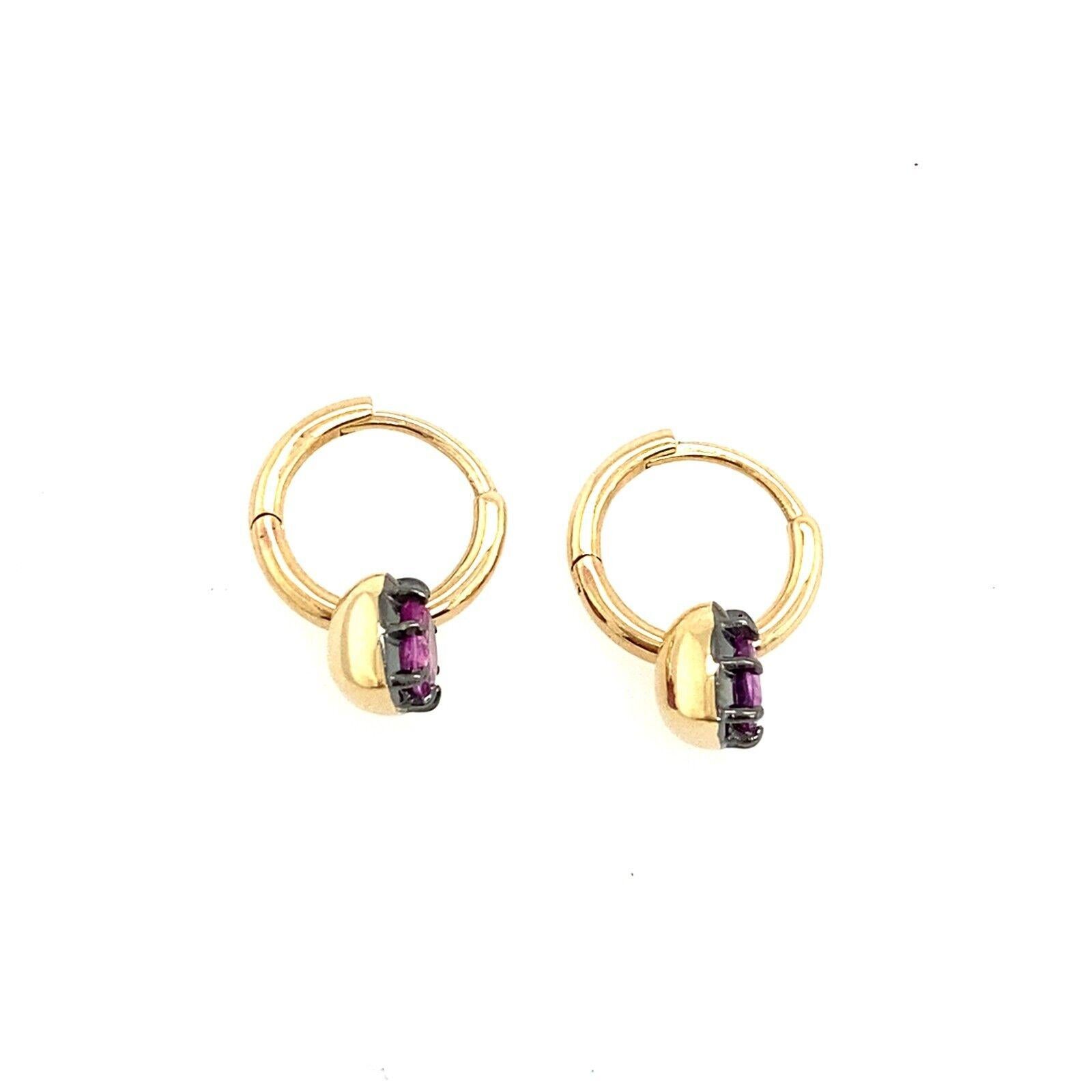 These stunning earrings are the perfect pair to add to your collection. These 14ct Yellow and Black Gold earrings have a total of 2 natural Pink Sapphires in a heart shape each one is set in a prong setting and attached to the hoop plain