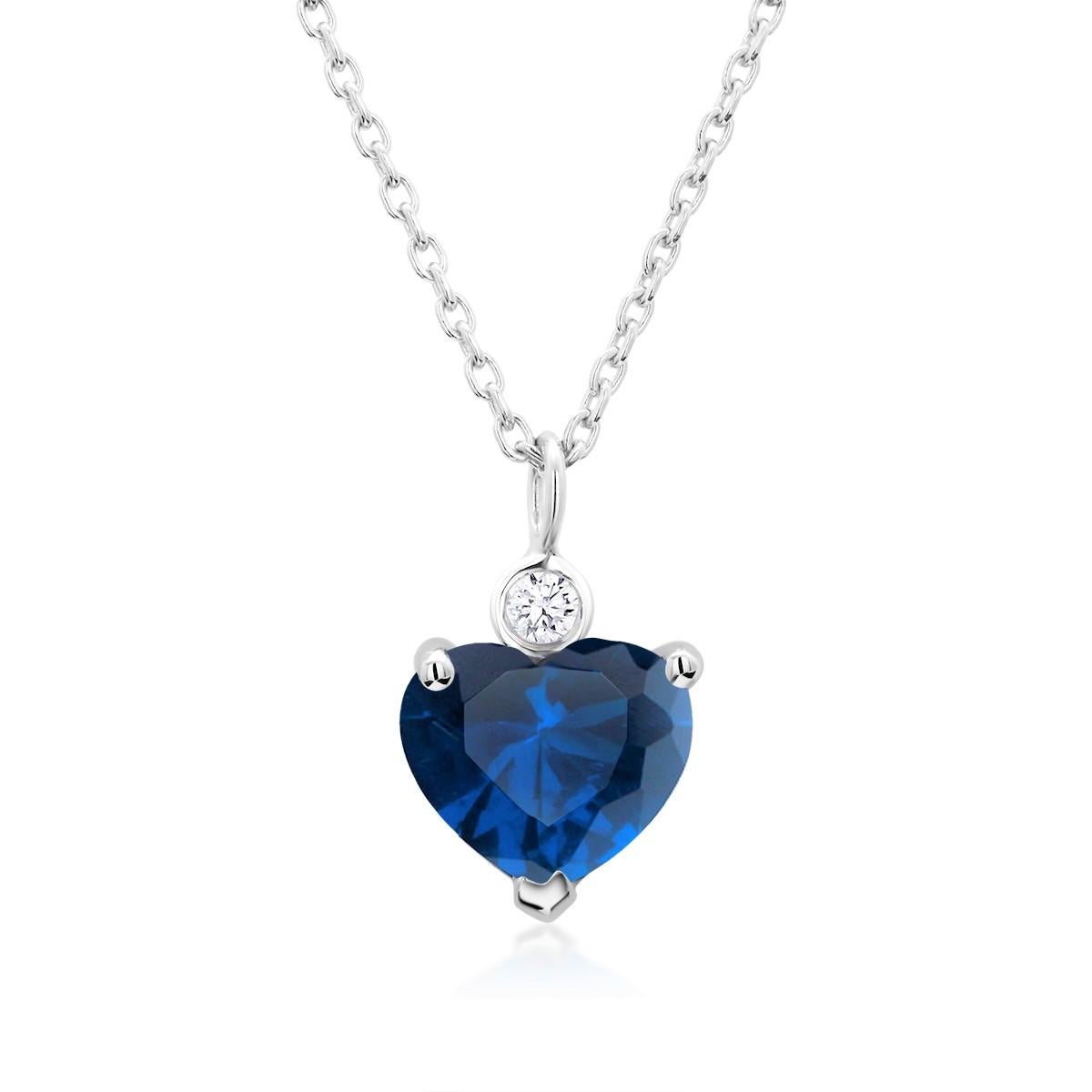 Fourteen karats white gold trending layered necklace pendant with hanging heart shape sapphire and diamond
Heart shape sapphire weighing 1.04 carat
The heart-shaped sapphire hue tone color is royal blue 
One diamond weighing 0.04 carats
Chain