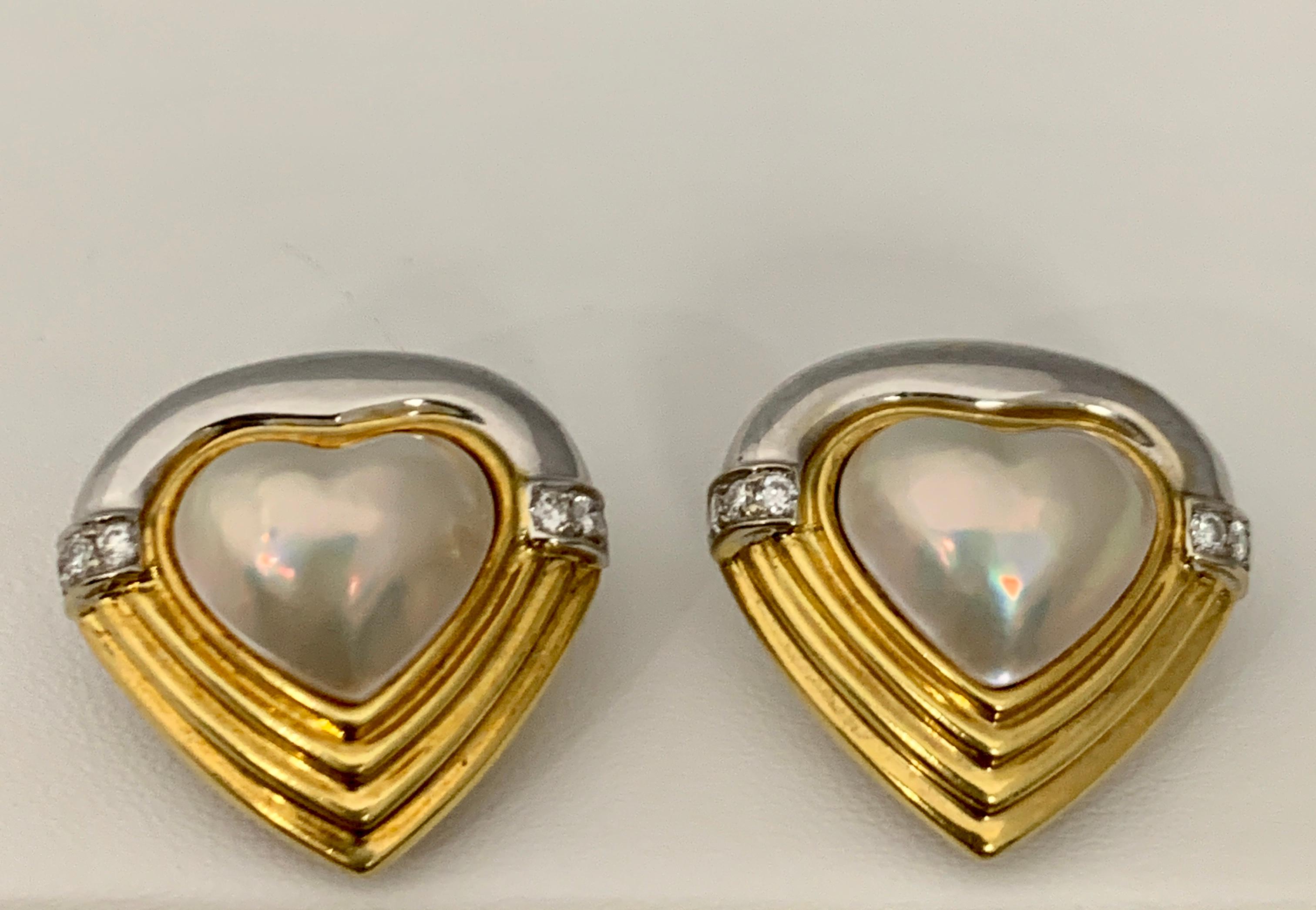 A beautiful pair of Heart Shape Mabe Pearl earrings with Diamonds set in Two tone white and yellow   18K gold
size of the heart Mother of Pearl 13X15 mm
All pearls are absolutely clean 
perfect pair made in 18 Karat White and Yellow gold
18 K Gold