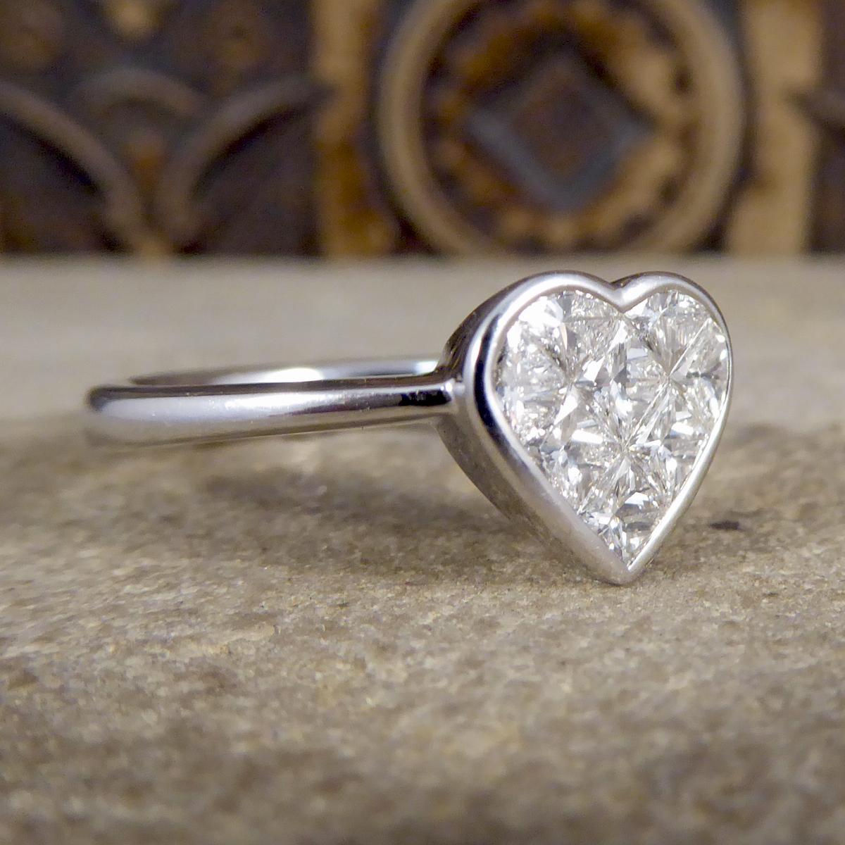 A magnificent heart shaped Diamond Ring with a total of 1.20cts made up from both Princess and Modified Princess cut Diamonds. This contemporary ring has a rub over collar setting and has been modelled in 18ct White Gold.

If your resize option