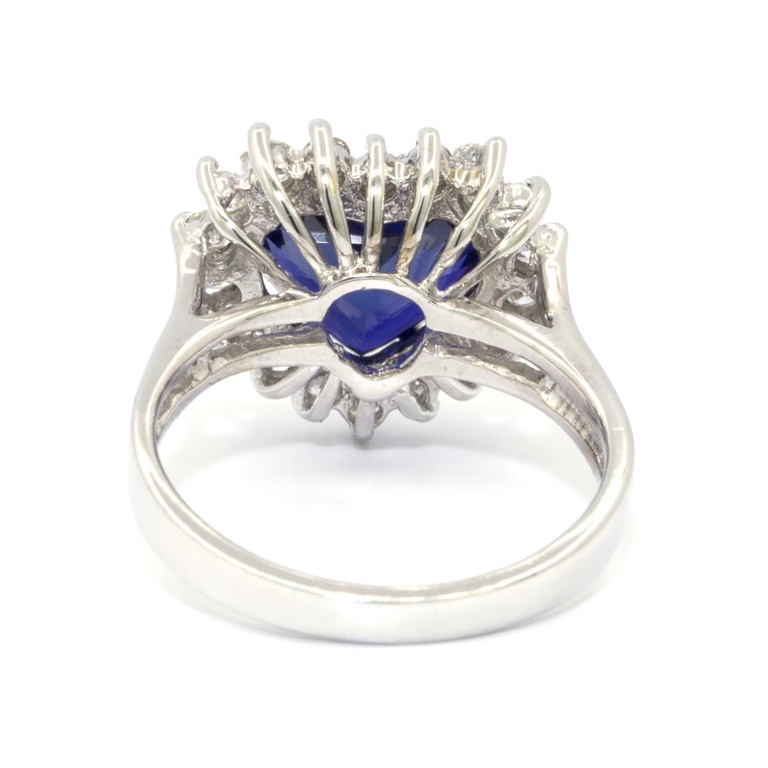 This Heart Shaped Sapphire and Diamond white gold Ring features a 3.87ct, rich blue, heart shaped natural sapphire that is surrounded by 18 rbc clean white prong set diamonds. The round white diamonds make the beautiful rich blue sapphire stand out