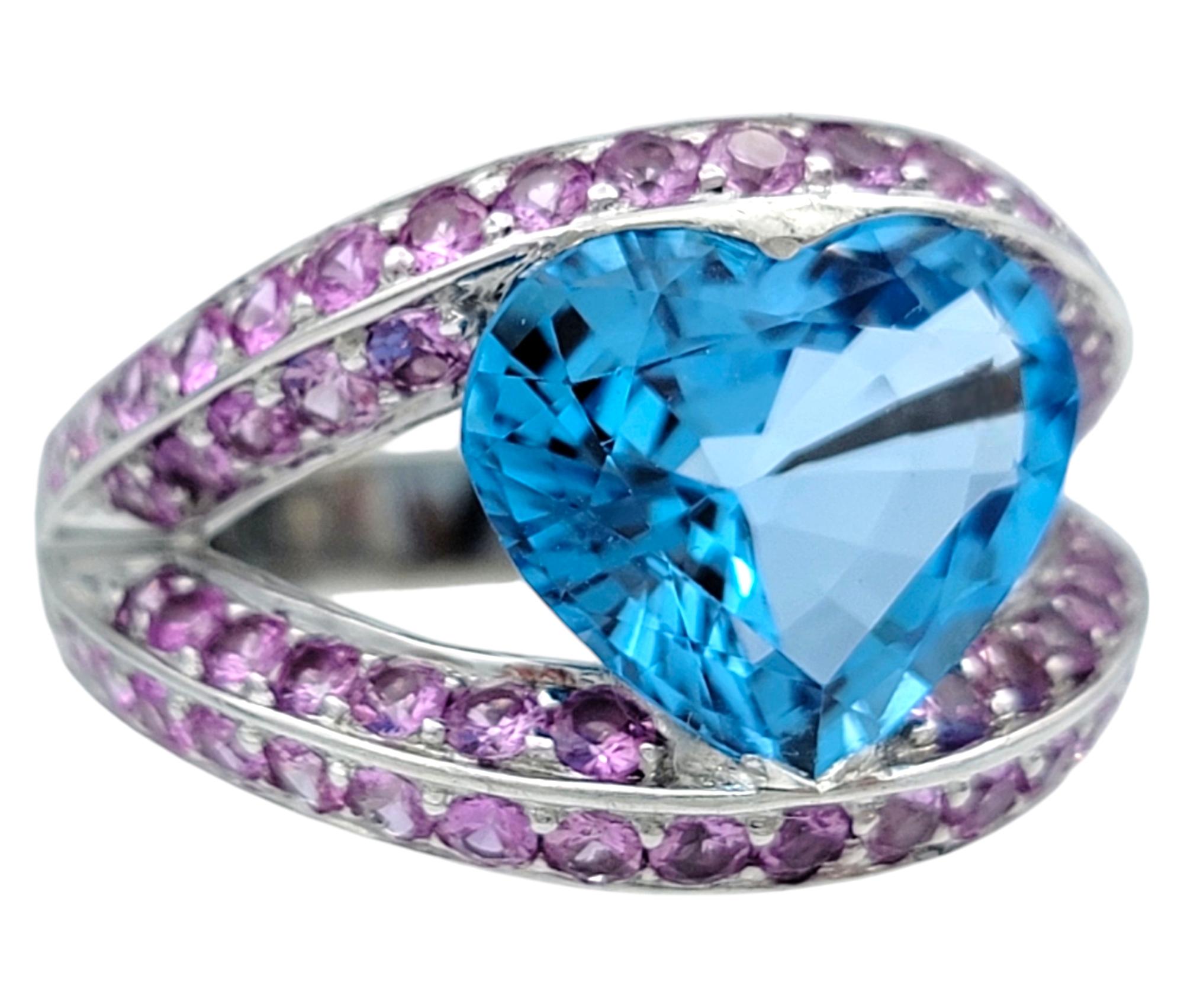 Contemporary Heart Shaped Blue Topaz Split Shank White Gold Cocktail Ring with Pink Sapphires For Sale