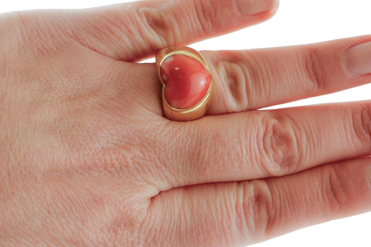 gold ring with red heart
