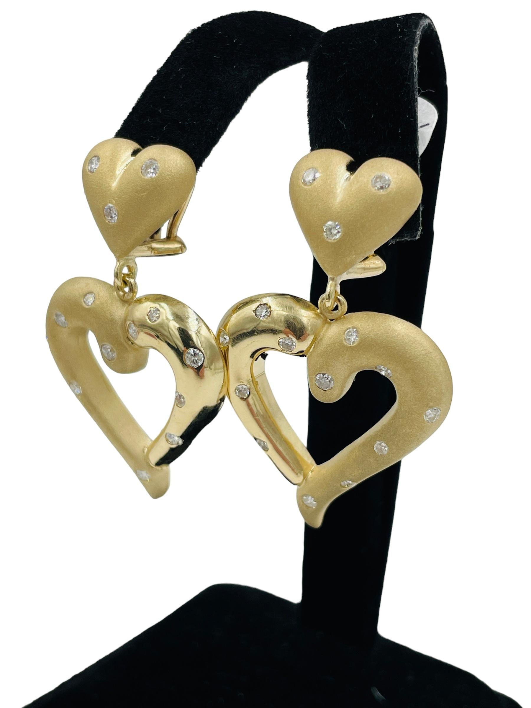 Heart Shaped Dangling 14k Yellow Gold Diamond Earrings

These heart-shaped dangling yellow gold diamond earrings are a timeless and elegant accessory that every woman should own.  The matt and shiny surfaces add exquisite detail to these earrings