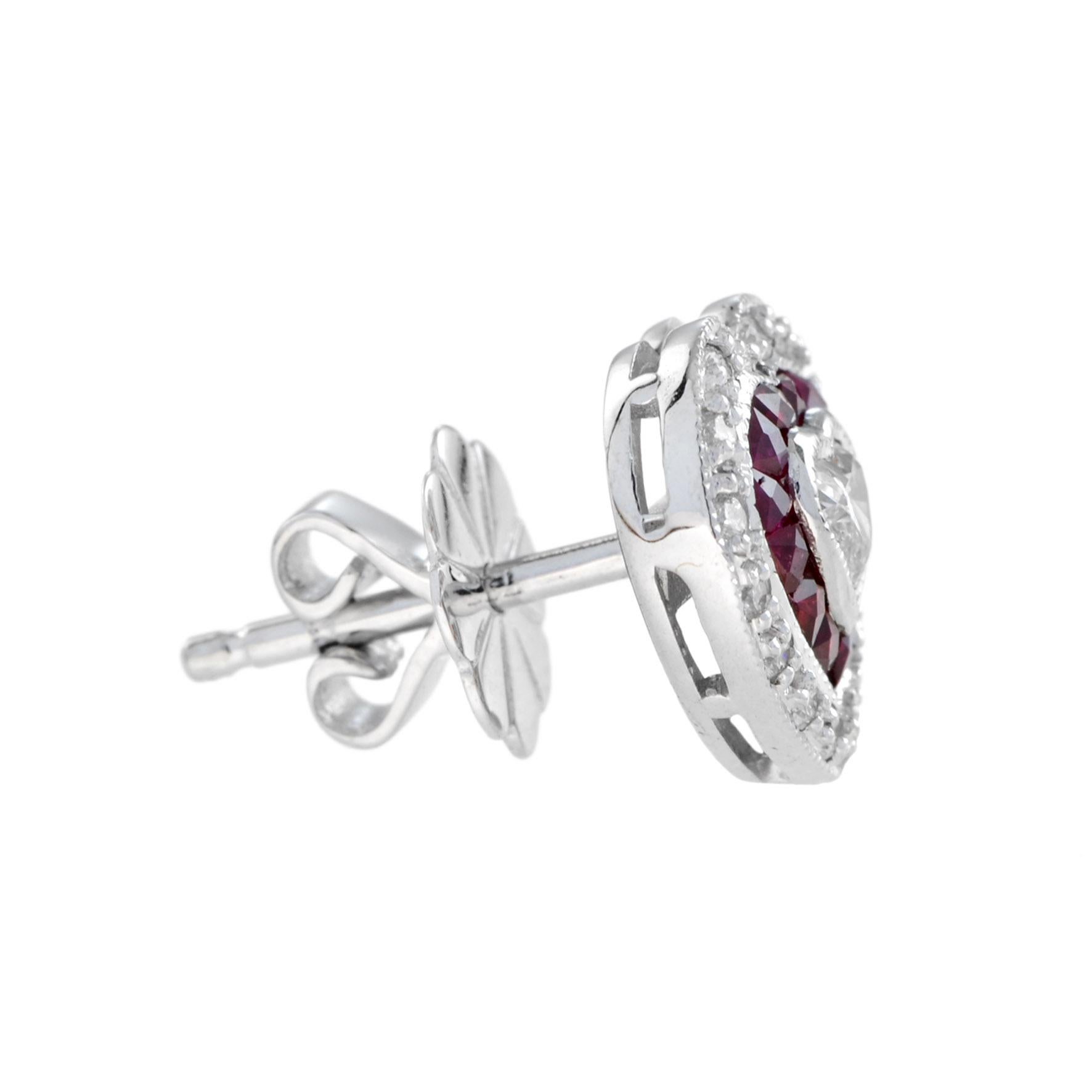 Crafted in 14k white gold, these lovely heart shaped stud earrings offer a beautiful combination of sophistication and charm. The center heart shaped diamonds weigh .25 carat in total and grade G color, VS clarity. A frame of French cut rubies, and