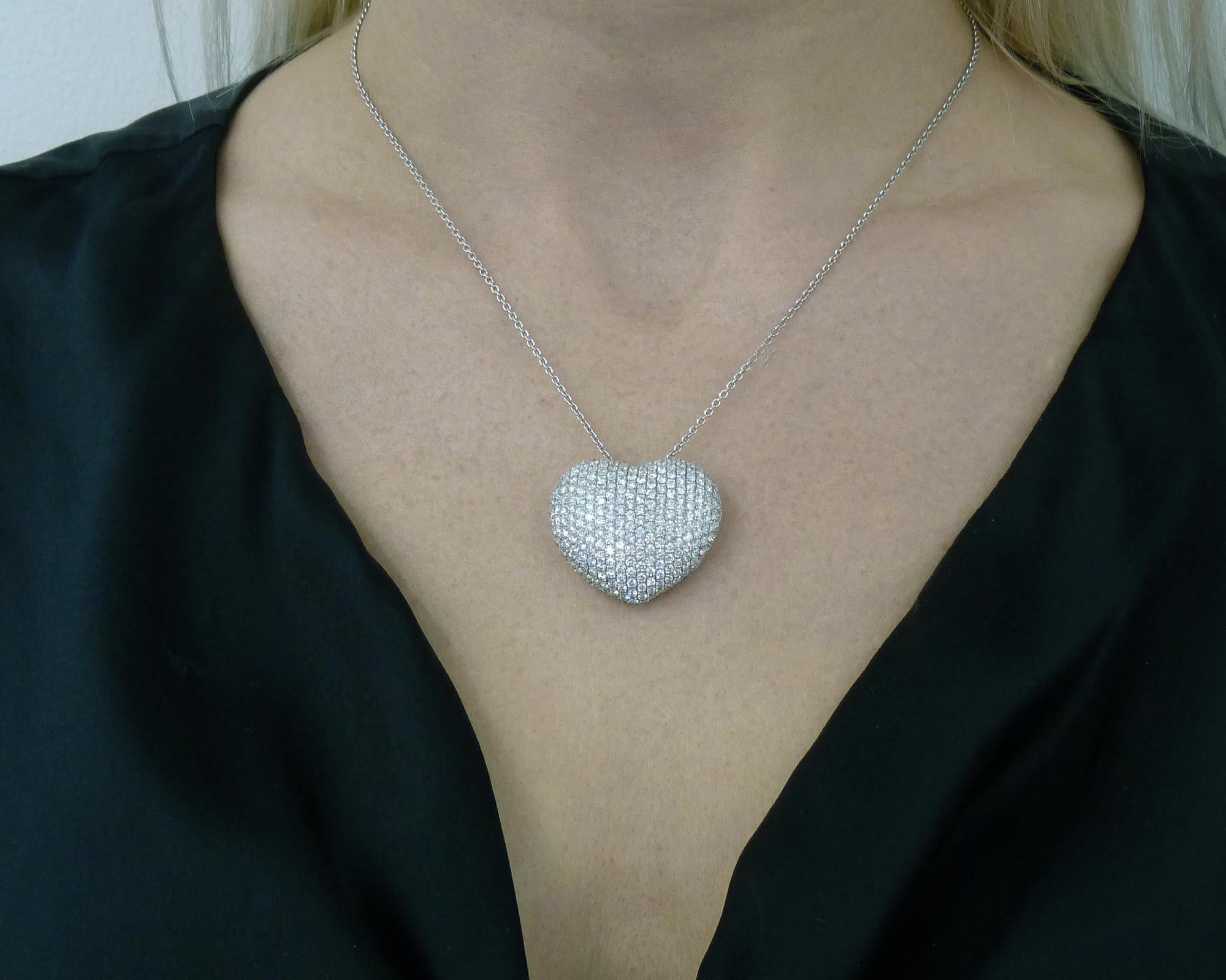 A beautiful necklace suspending a pendant shaped as a heart and encrusted with round diamonds. 
Diamonds are lively and bright, and equivalent to F-G colors, VVS-VS clarity.
Total weight of diamonds is approximately 7.50 carats. 
The metal is 18K