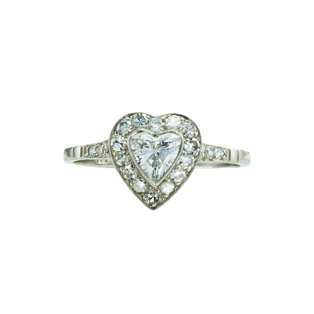 F-G color heart-shaped diamond and platinum engagement ring. *

ABOUT THIS ITEM:  #R-DJ629A. Scroll down for specifications.  Centering upon a high-quality heart-shaped diamond within a conforming border set with round diamonds to the shoulders. The