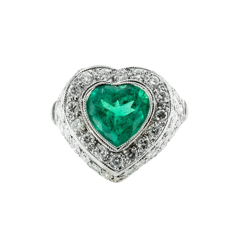 Heart-shaped emerald and diamond estate platinum ring.  *

ABOUT THIS ITEM:  #R-DJ28B. Scroll down for detailed specifications.  The emerald shows a nice green color while surrounded by a multitude of diamonds.  It is a ring that can be worn as a