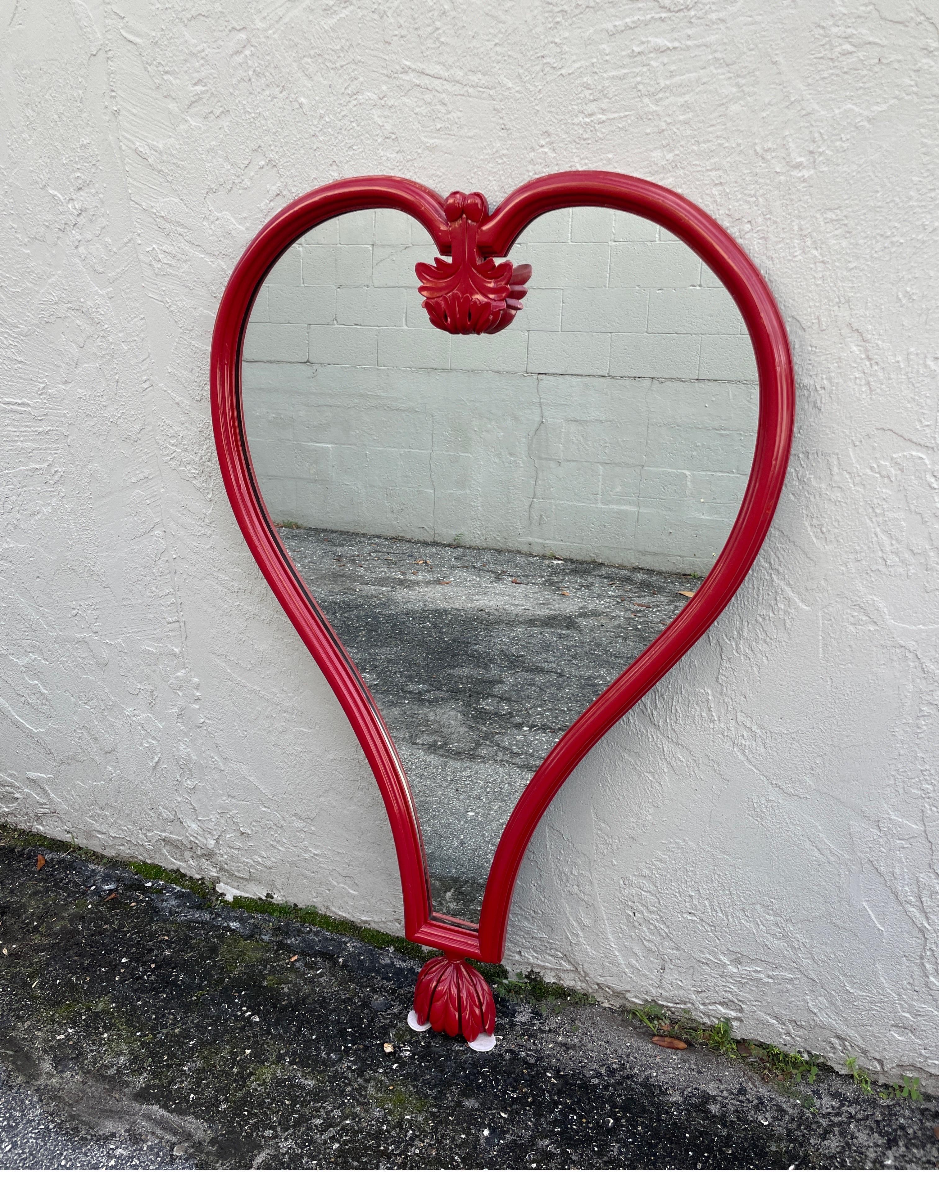 Parisian influenced Hollywood Regency Heart shaped mirror in a red lacquer finish. This very unique mirror is very chic and quite unusual.