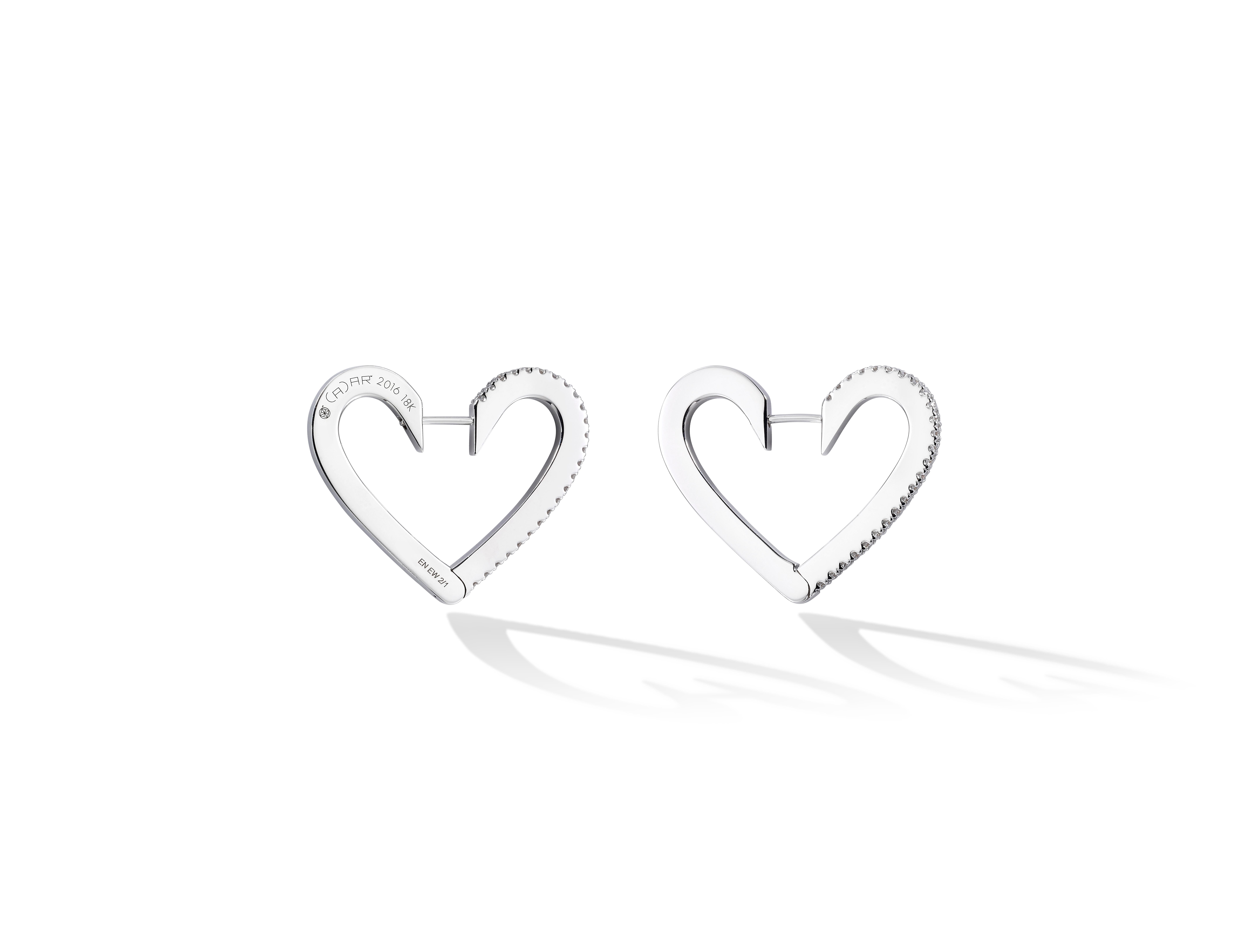 Euphoria of love. These heart-shaped hoops recall the vibrant sensation of fluttering butterflies brought on by new love. Handcrafted in high polished 18K yellow gold and .60cttw white GVVS-2 diamonds, and fastened by a discrete hidden post. Also