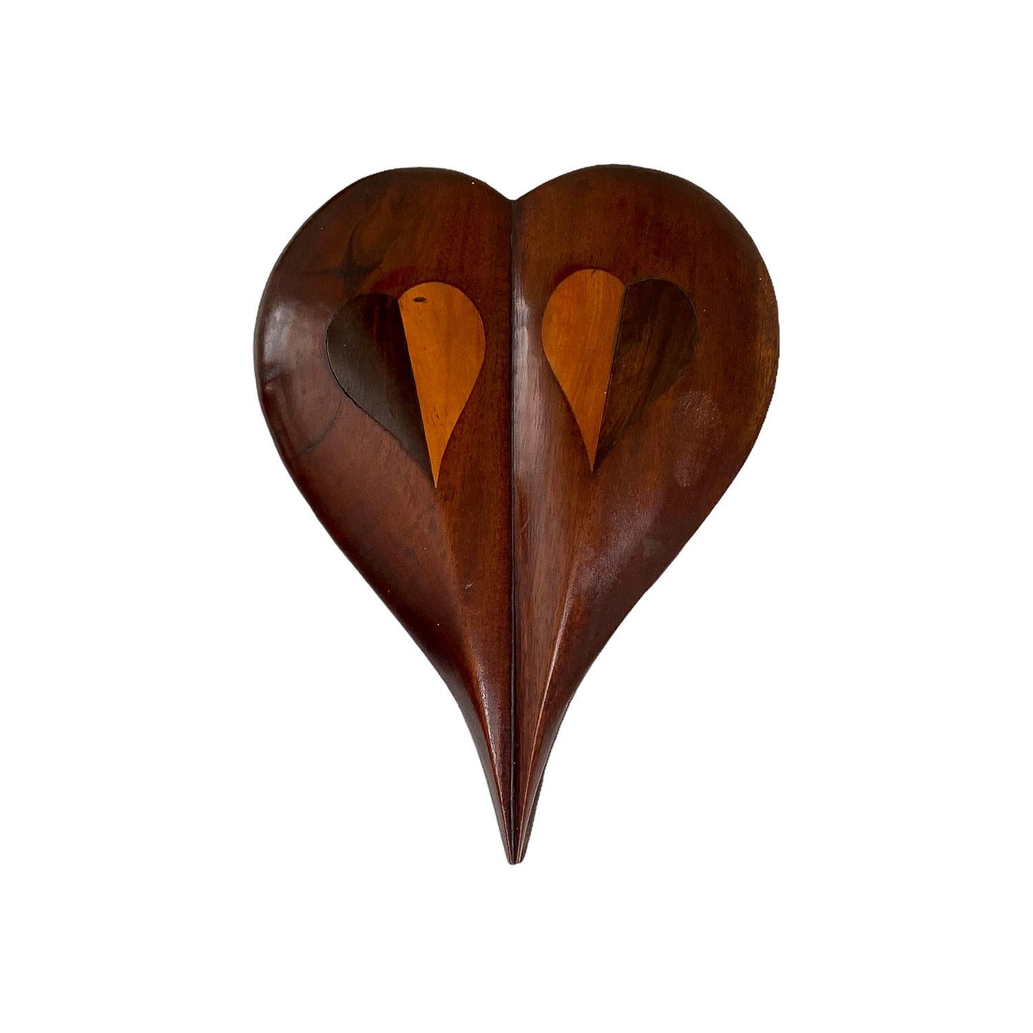 Heart shaped mahogany lift top box, domed with
heart inlay of fruitwood and stained mahogany.
American, circa 1930-1940
Measures: 2 ½” x 8 ½” x 6 ¼”.