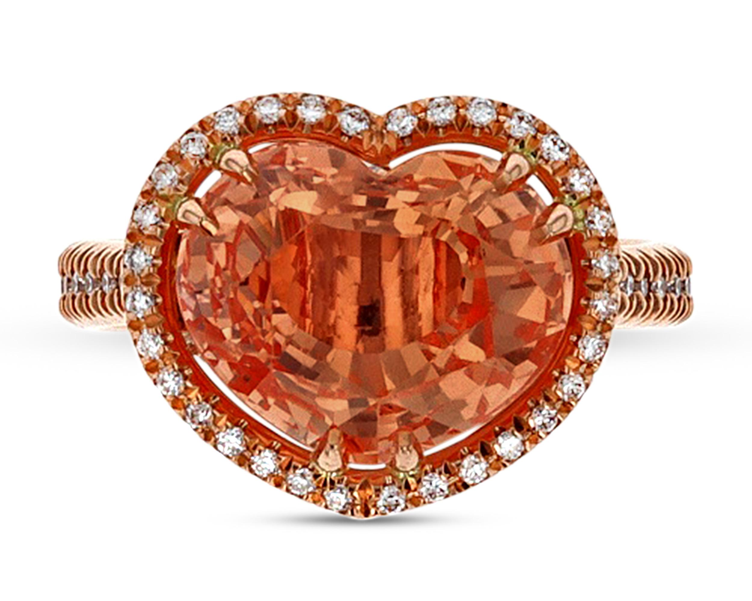 This exquisite ring features a Padparadscha sapphire, the rarest of all sapphires. Weighing 5.95 carats, this heart-shaped gem displays the pinkish-orange color that makes these stones so highly coveted. The sapphire is certified by the Gemresearch
